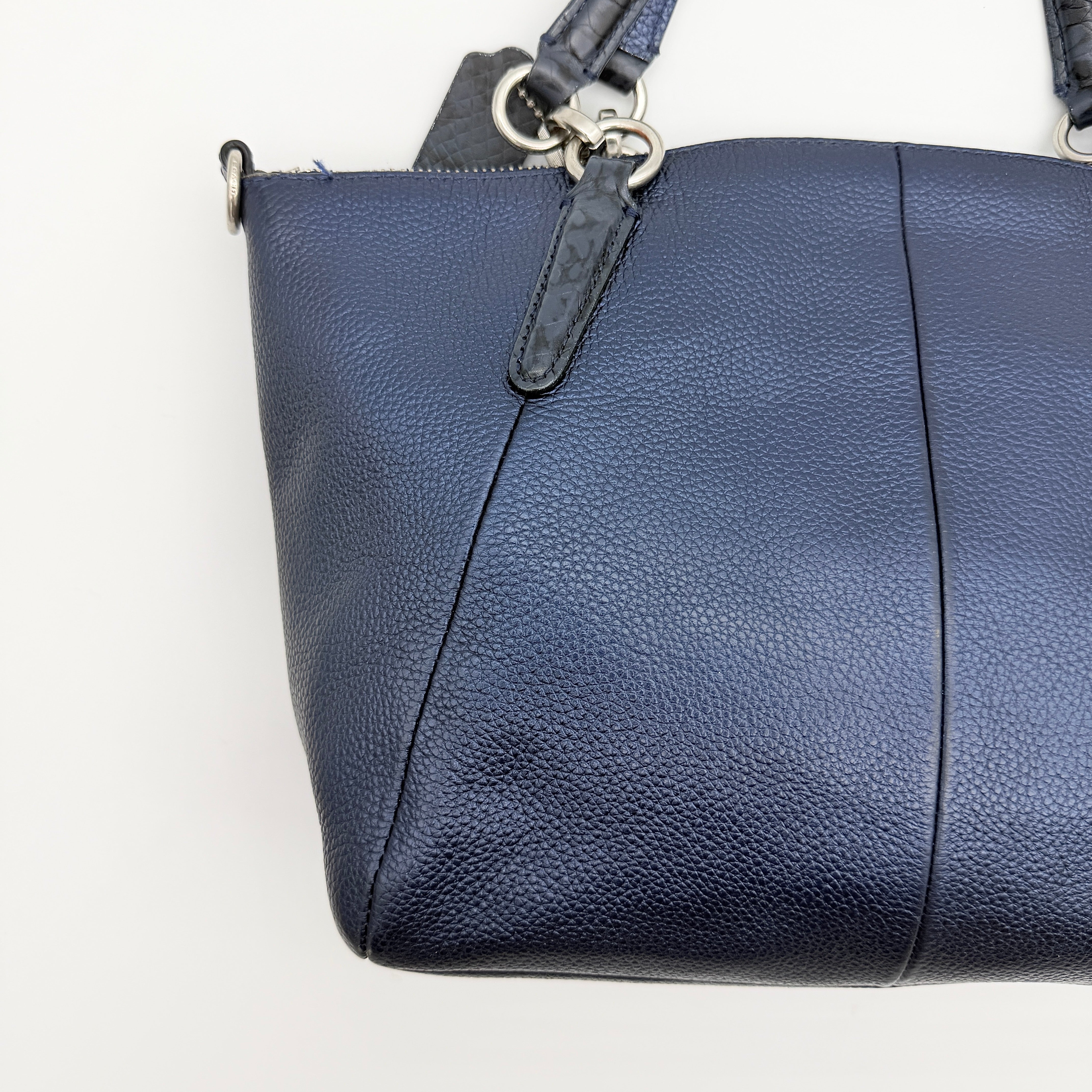 Coach Kelsey 2Way shoulder bag in navy blue pebble leather with silver-tone hardware, shown with detachable strap.