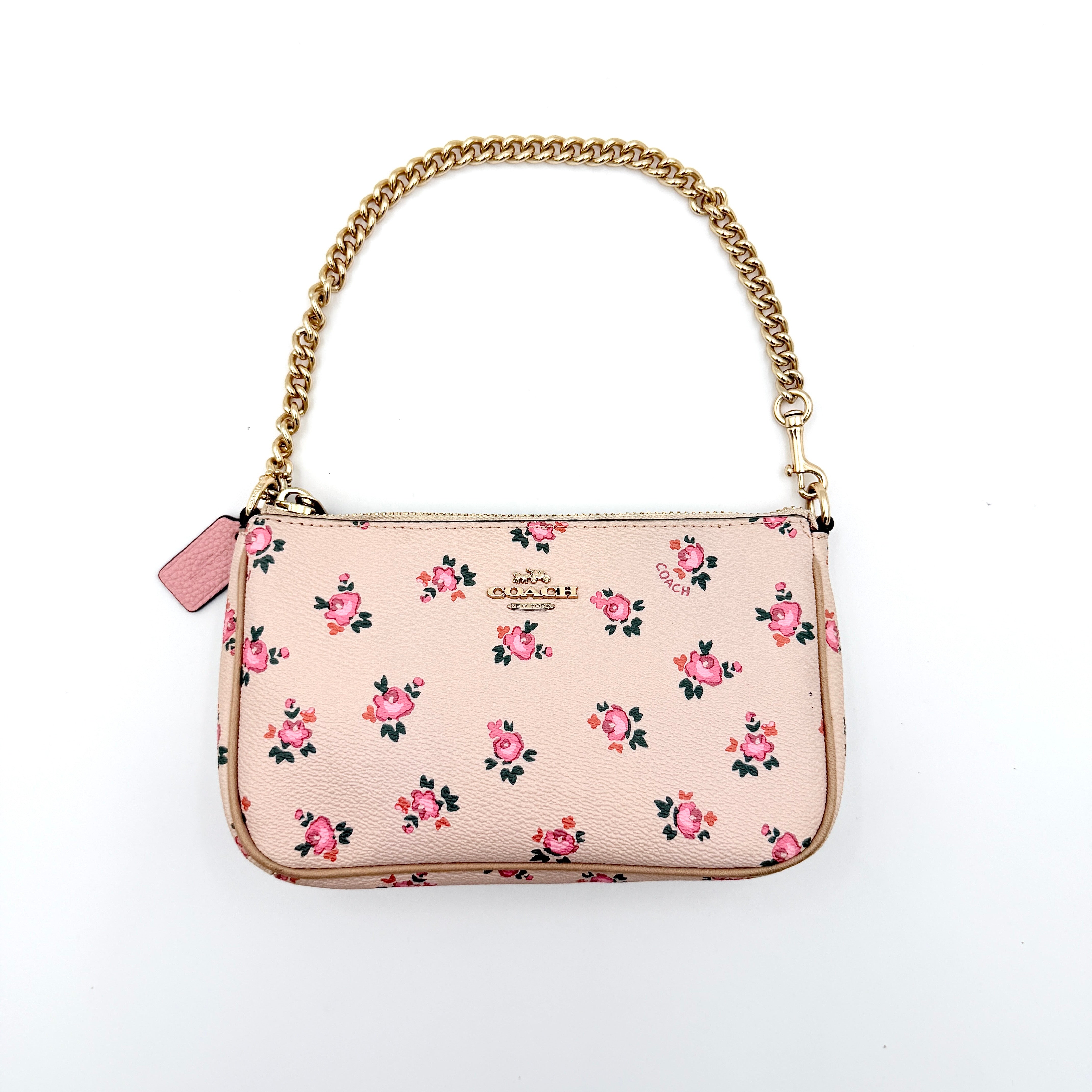 Coach Nolita 19 pink shoulder bag in floral print with gold chain handle, photographed against a white background.