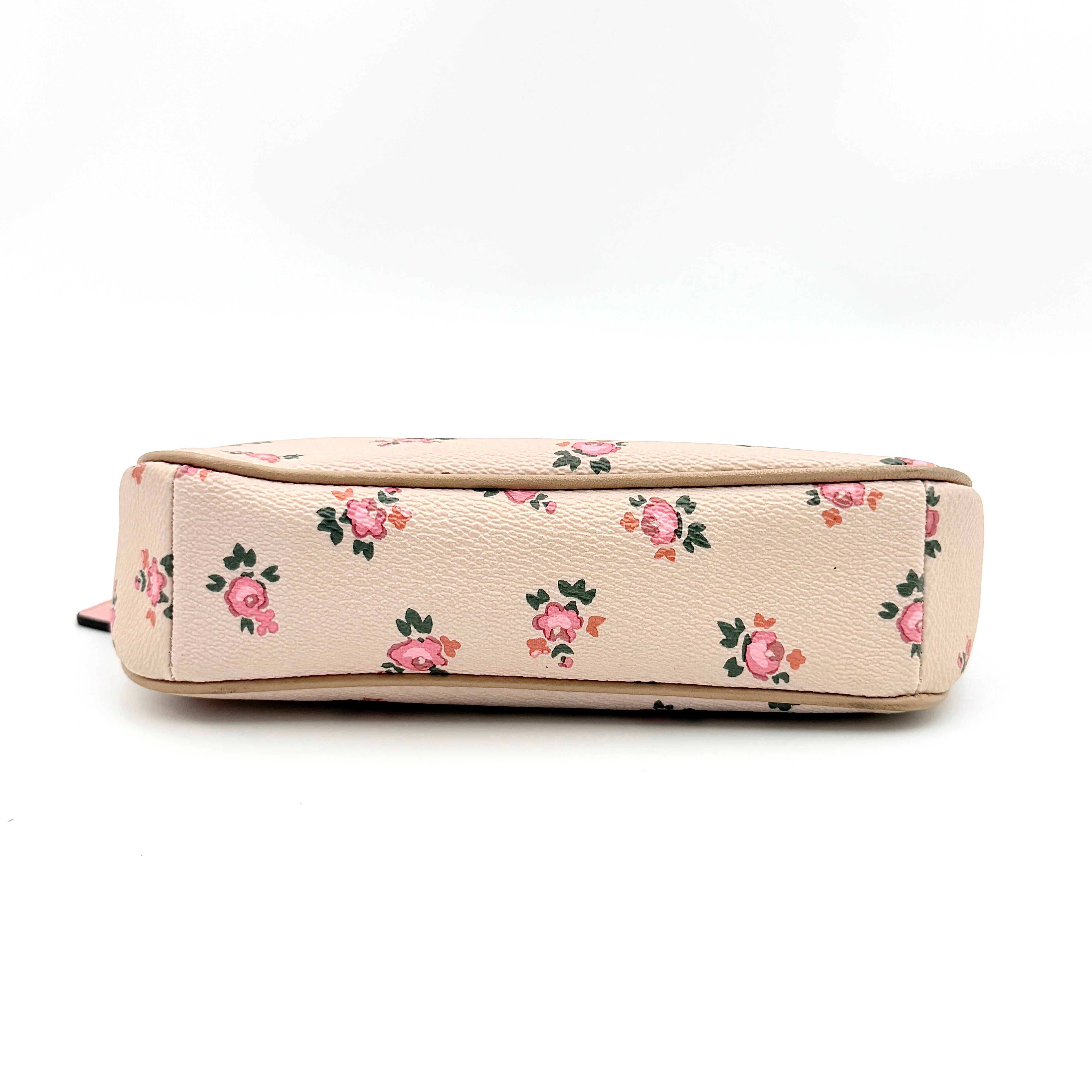 Coach Nolita 19 pink shoulder bag in floral print with gold chain handle, photographed against a white background.