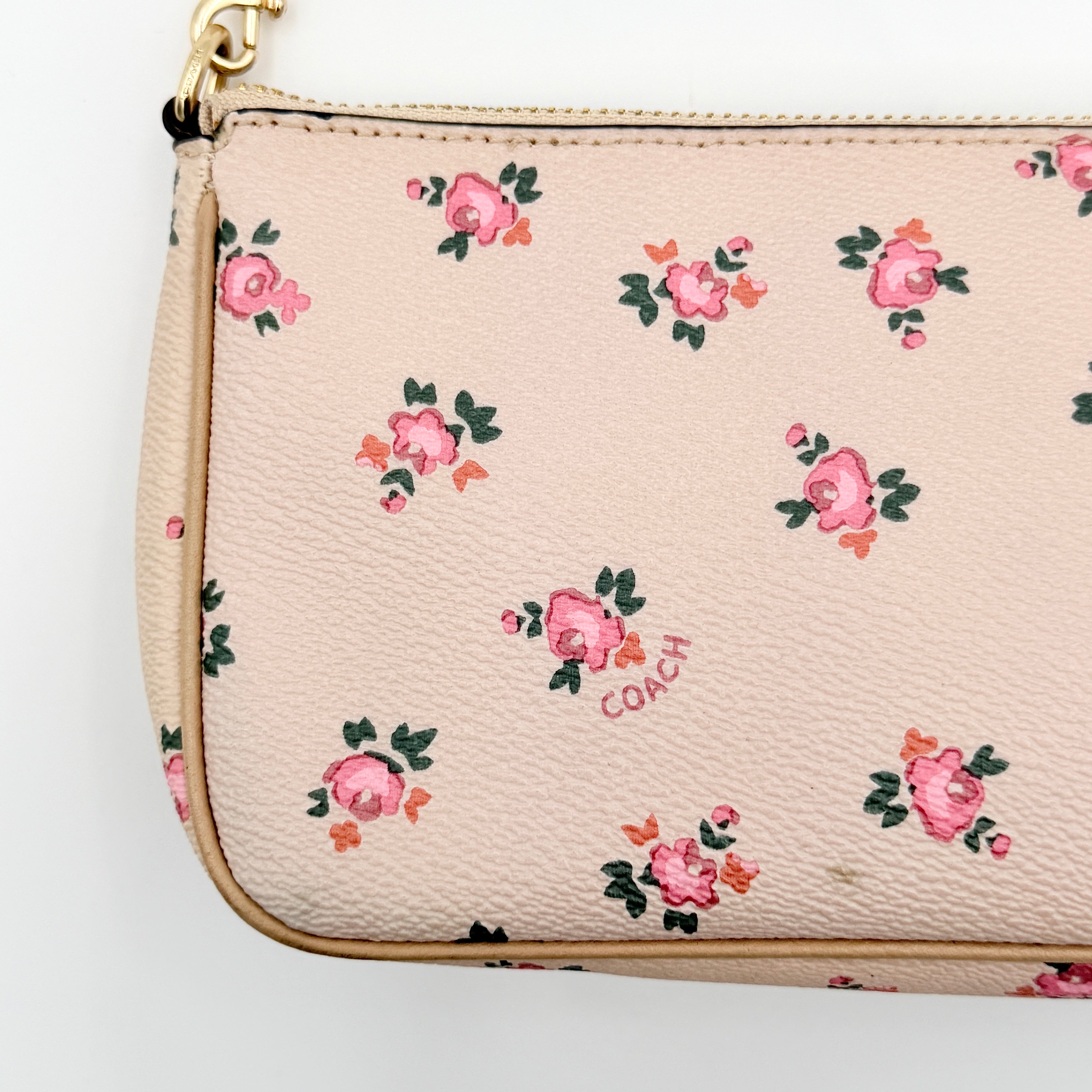 Coach Nolita 19 pink shoulder bag in floral print with gold chain handle, photographed against a white background.