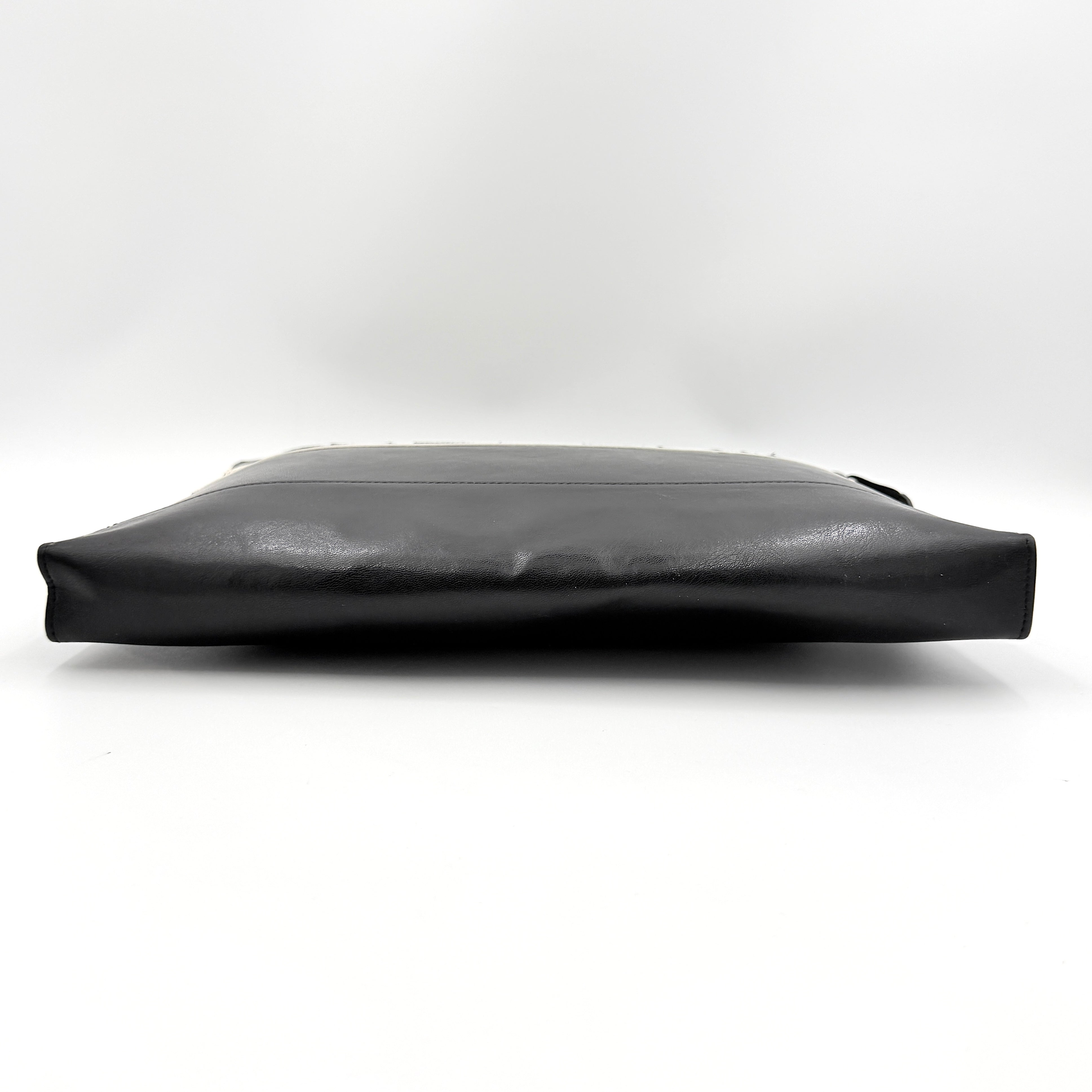 Front view of a Givenchy black leather clutch with bold white logo panel and red zip pull.