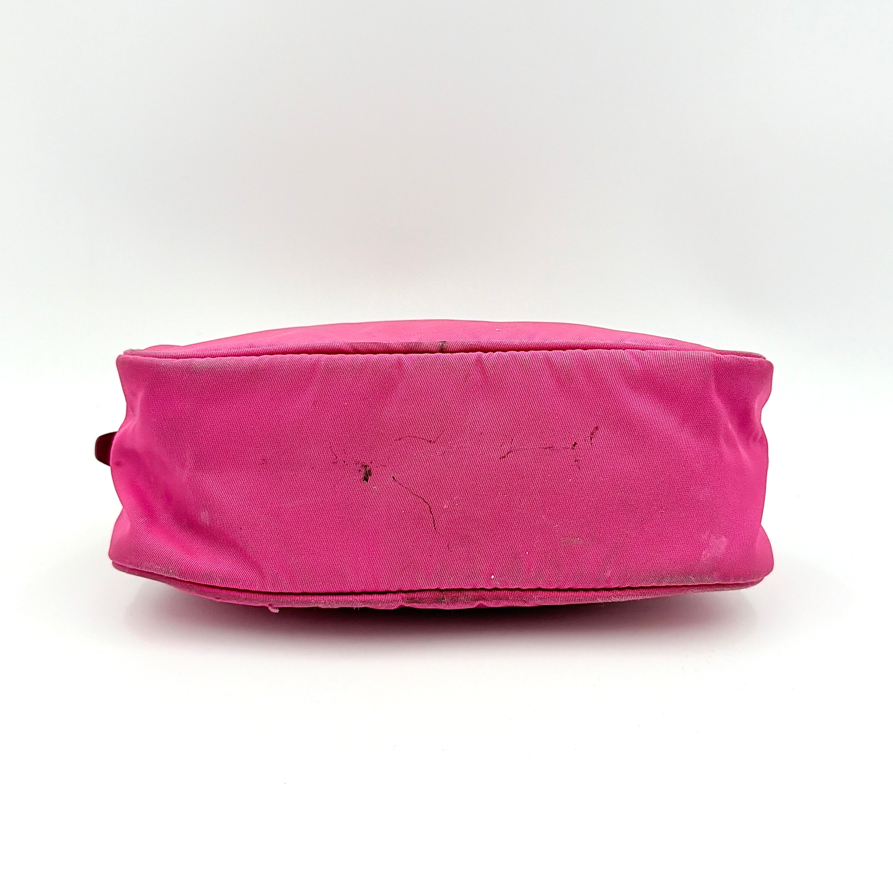 Prada Tessuto Nylon Pouch in vibrant pink with gold-tone hardware and triangle logo, showing visible wear on the exterior.