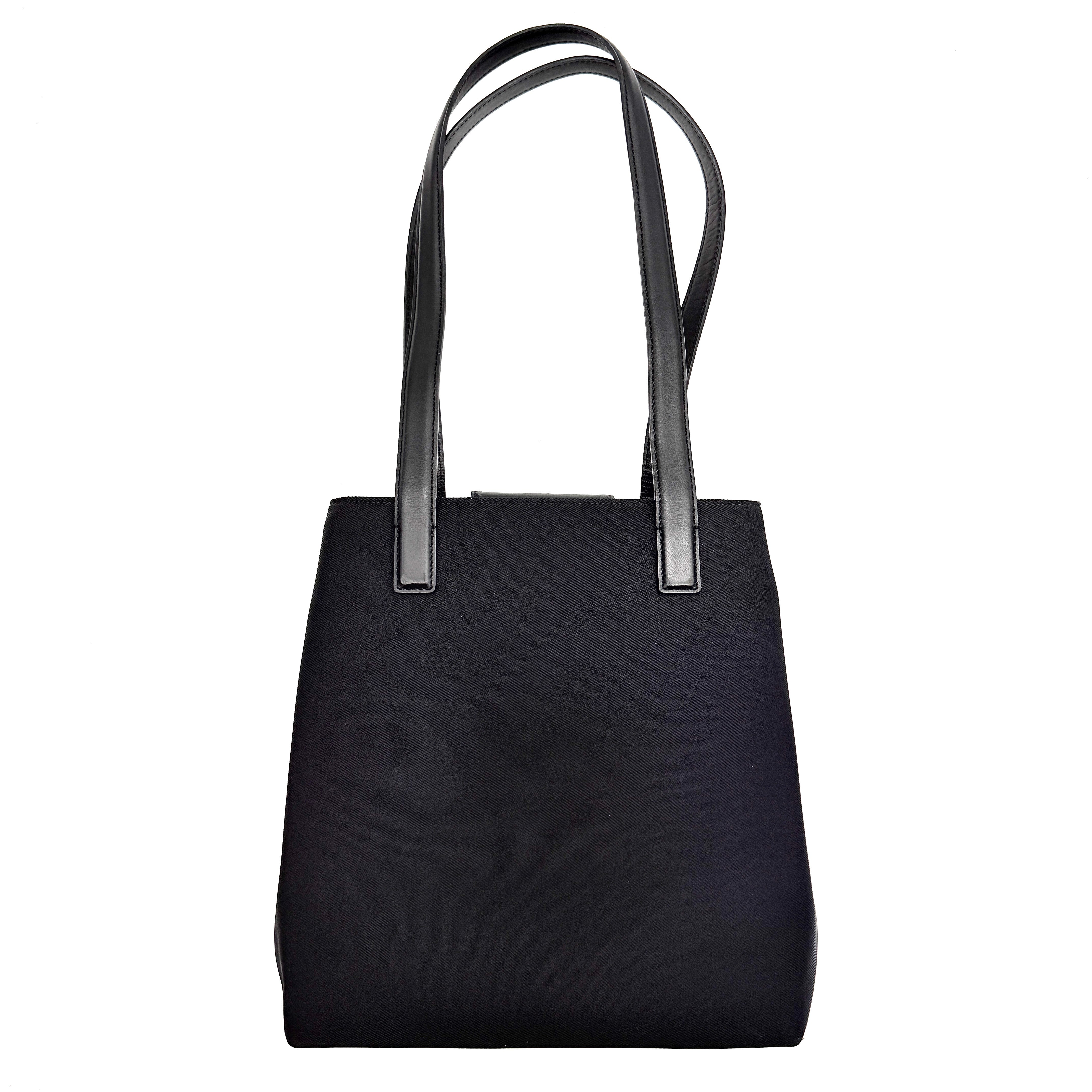 Coach Mercer Nylon Tote Bag in black with leather handles and silver Coach tag, photographed on a white background.