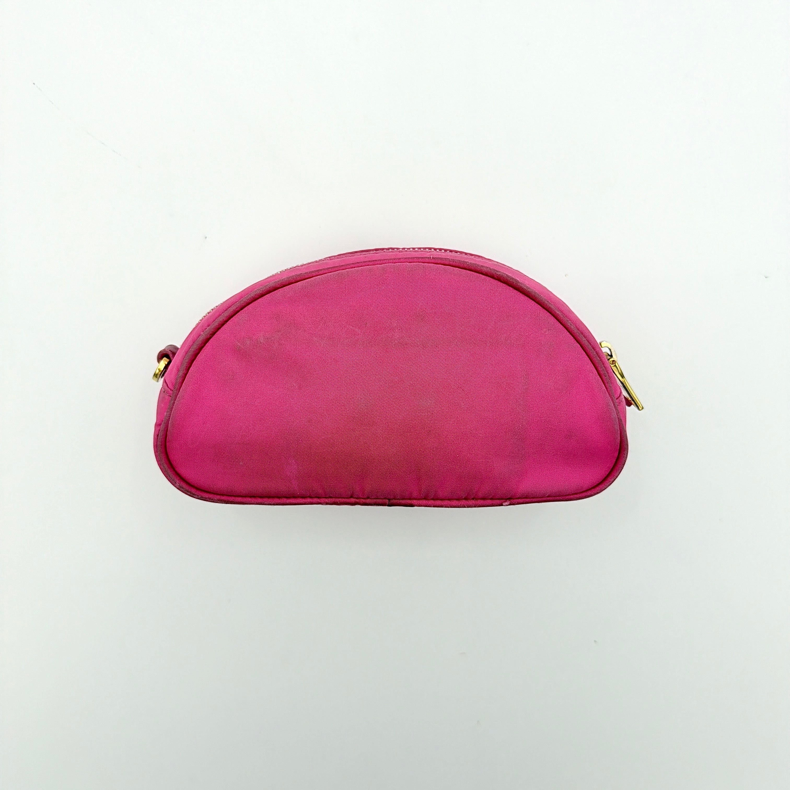 Prada Tessuto Nylon Pouch in vibrant pink with gold-tone hardware and triangle logo, showing visible wear on the exterior.