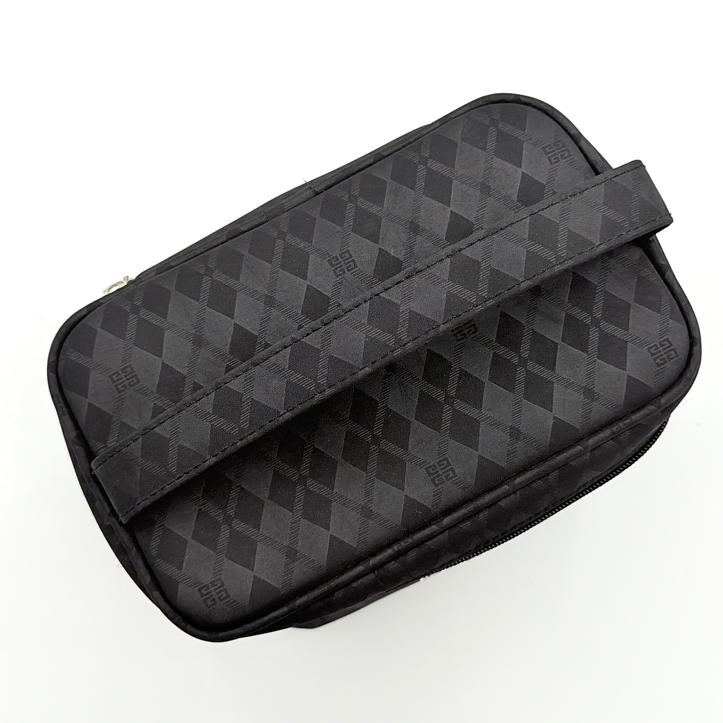 Givenchy vanity bag in black with rhinestone logo, geometric pattern, and top handle, shown from the front.