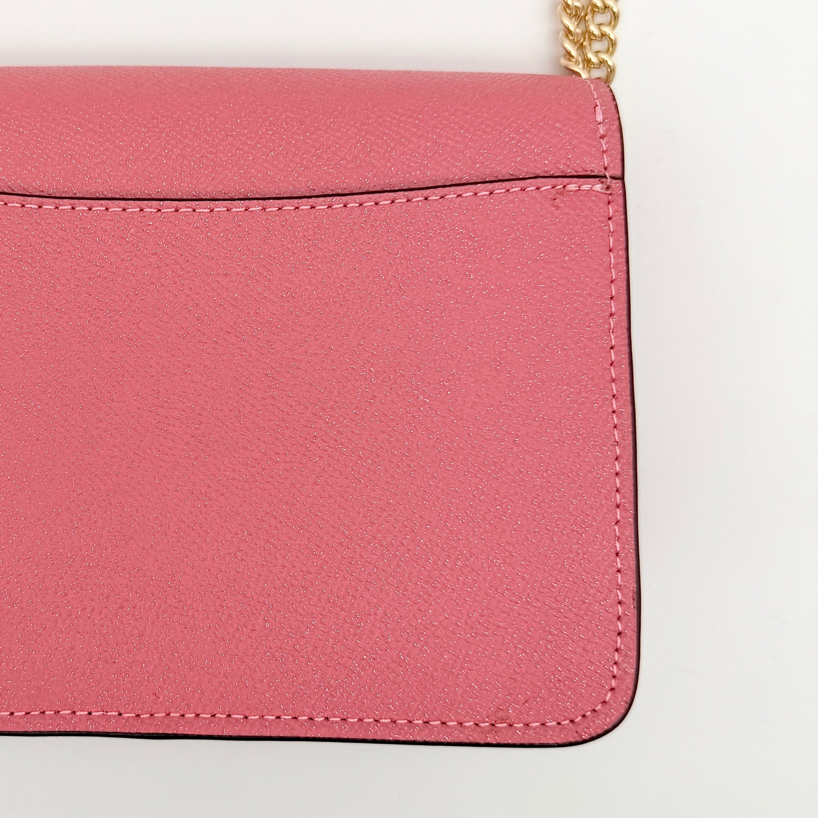 Coach Bowery Turnlock shoulder bag in pink saffiano leather with a gold-tone chain strap and signature Coach hangtag.