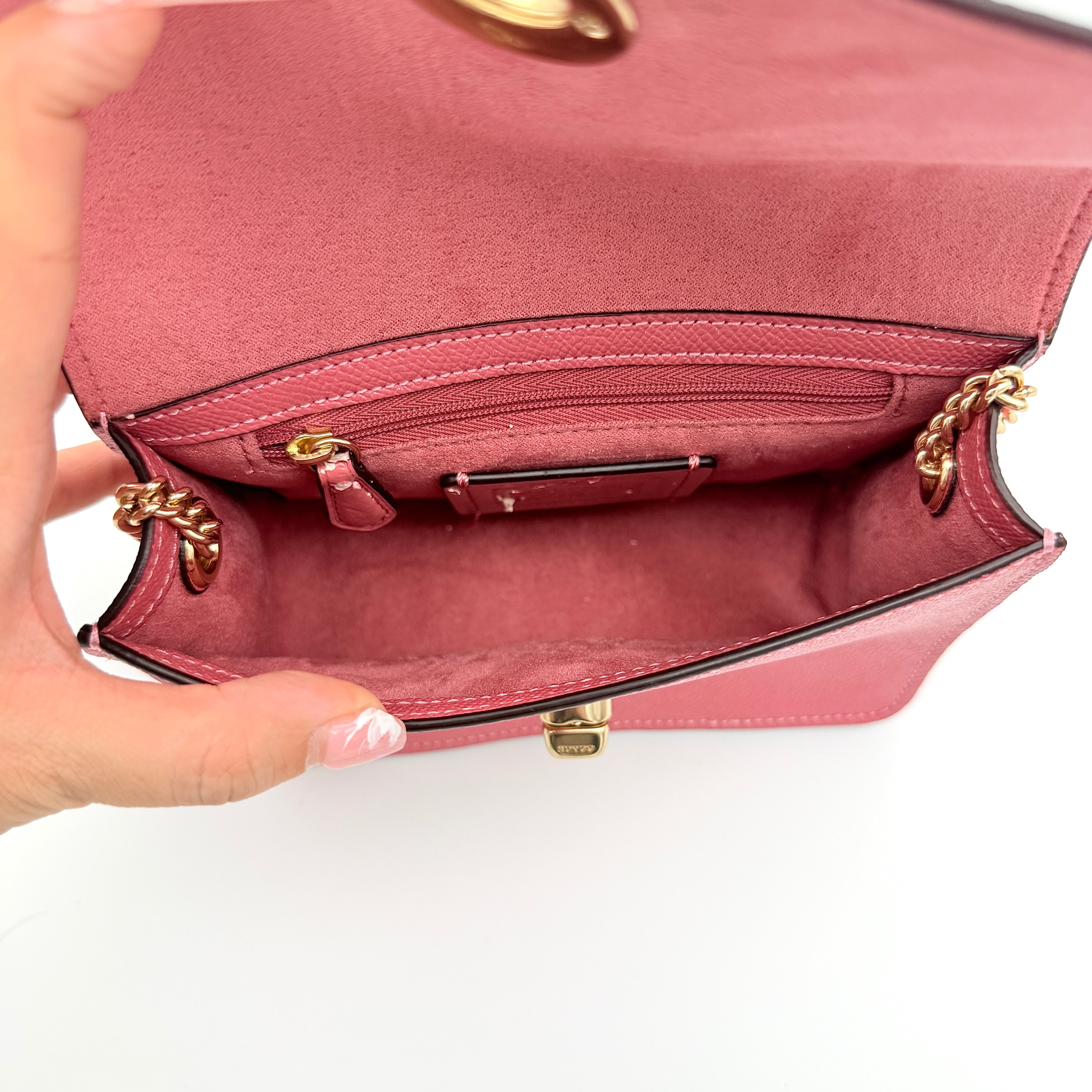 Coach Bowery Turnlock shoulder bag in pink saffiano leather with a gold-tone chain strap and signature Coach hangtag.