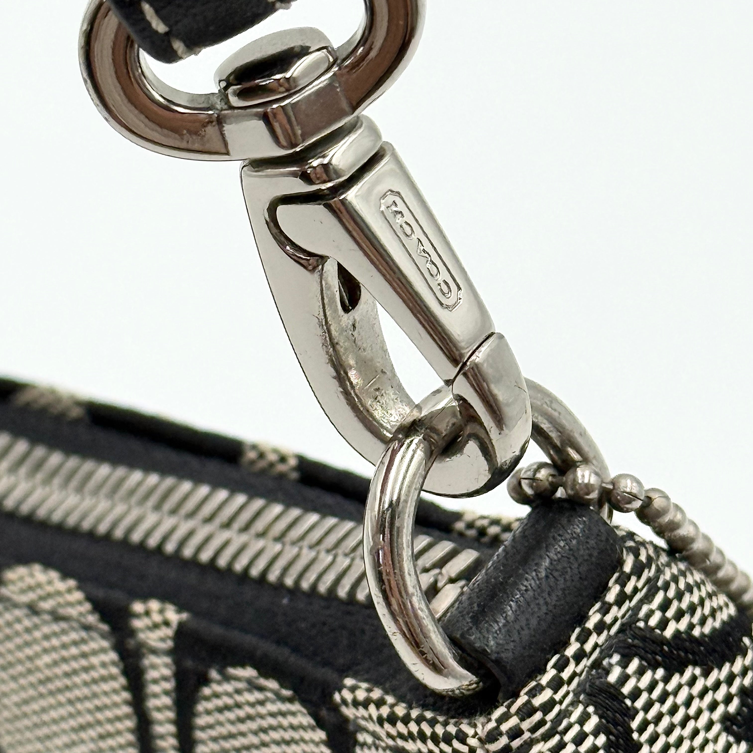 Coach Y2K Demi Shoulder Bag in black and grey signature jacquard with black leather trim and detachable Coach tag.