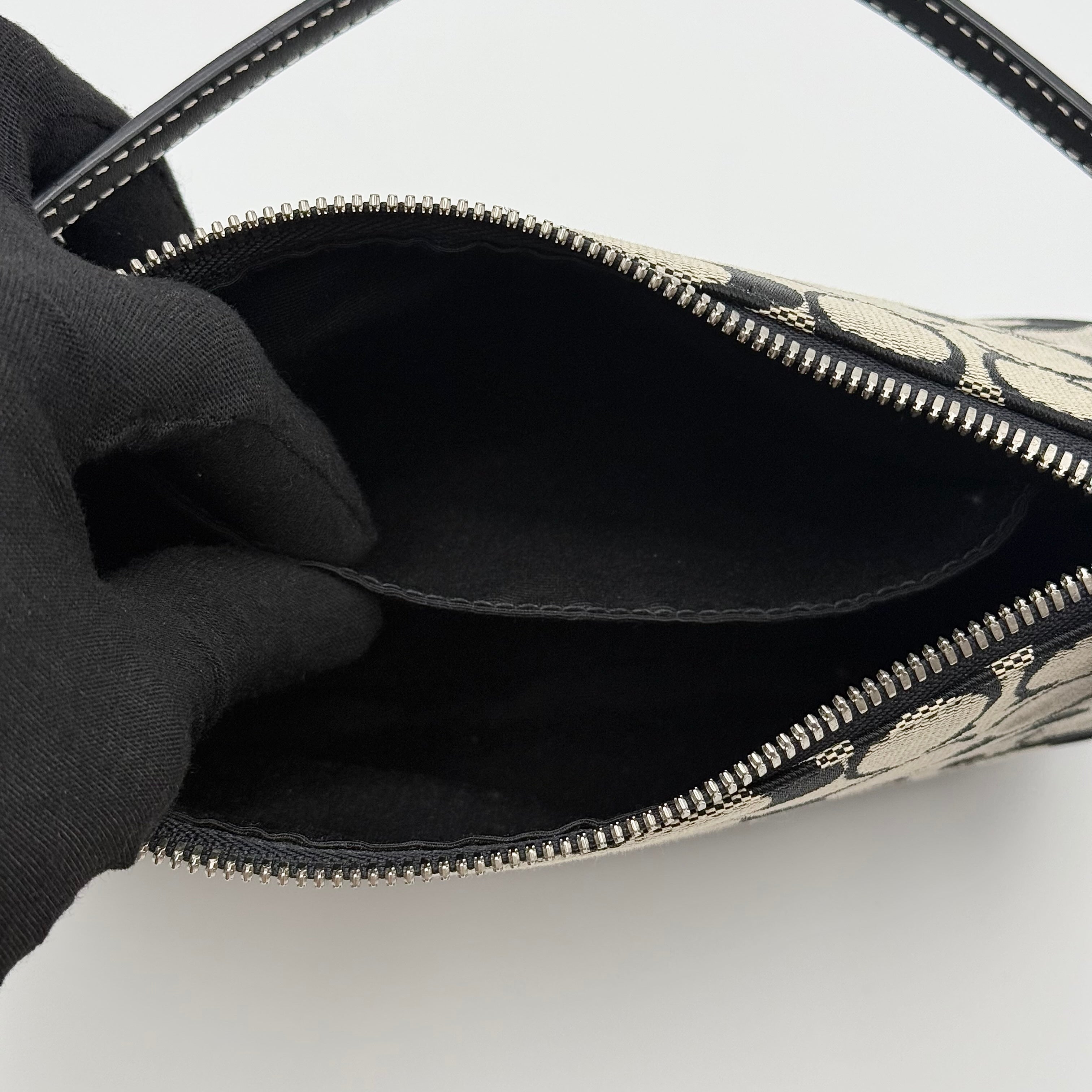 Coach Y2K Demi Shoulder Bag in black and grey signature jacquard with black leather trim and detachable Coach tag.