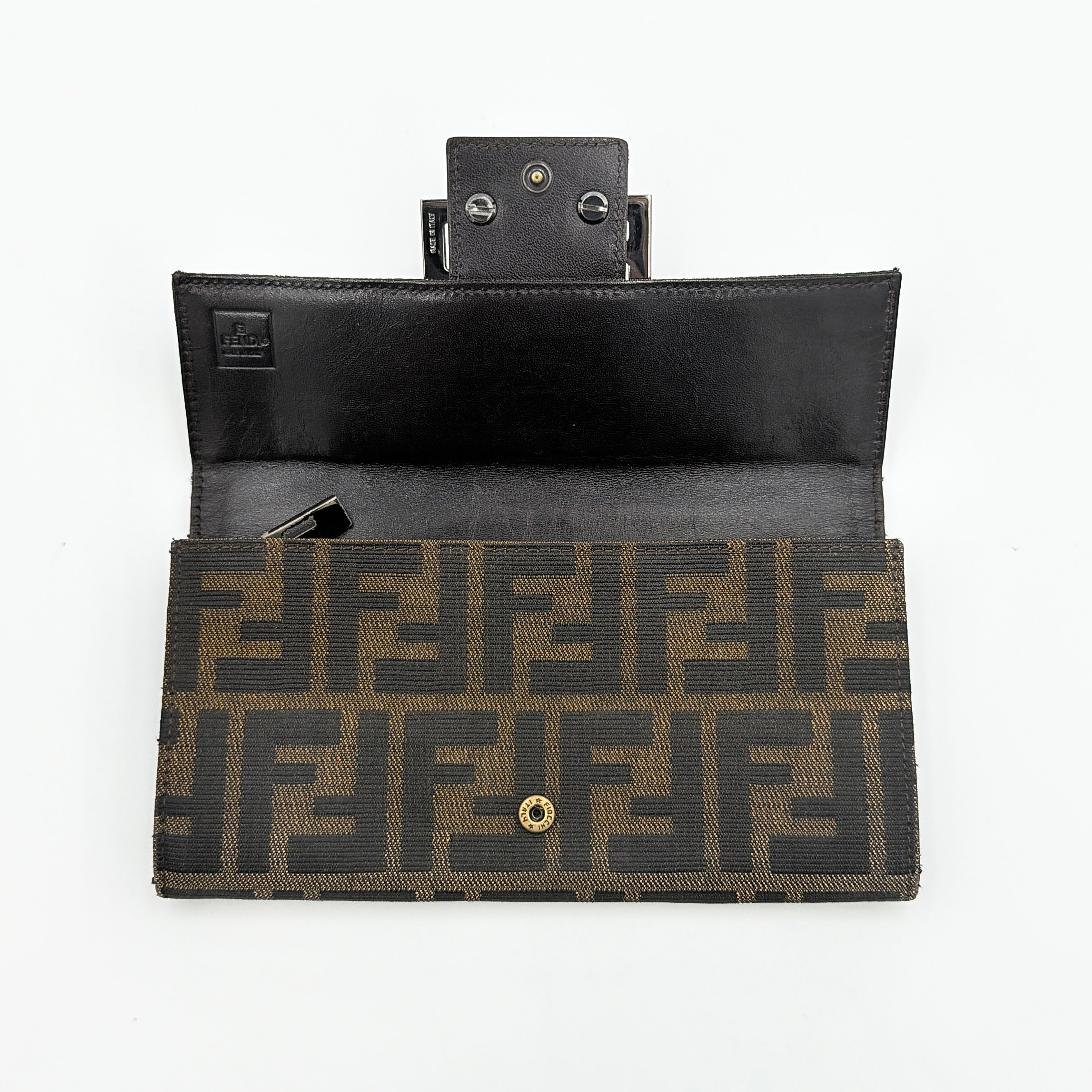 Front view of the Fendi FF Zucca long wallet in brown with signature monogram canvas and silver logo buckle.
