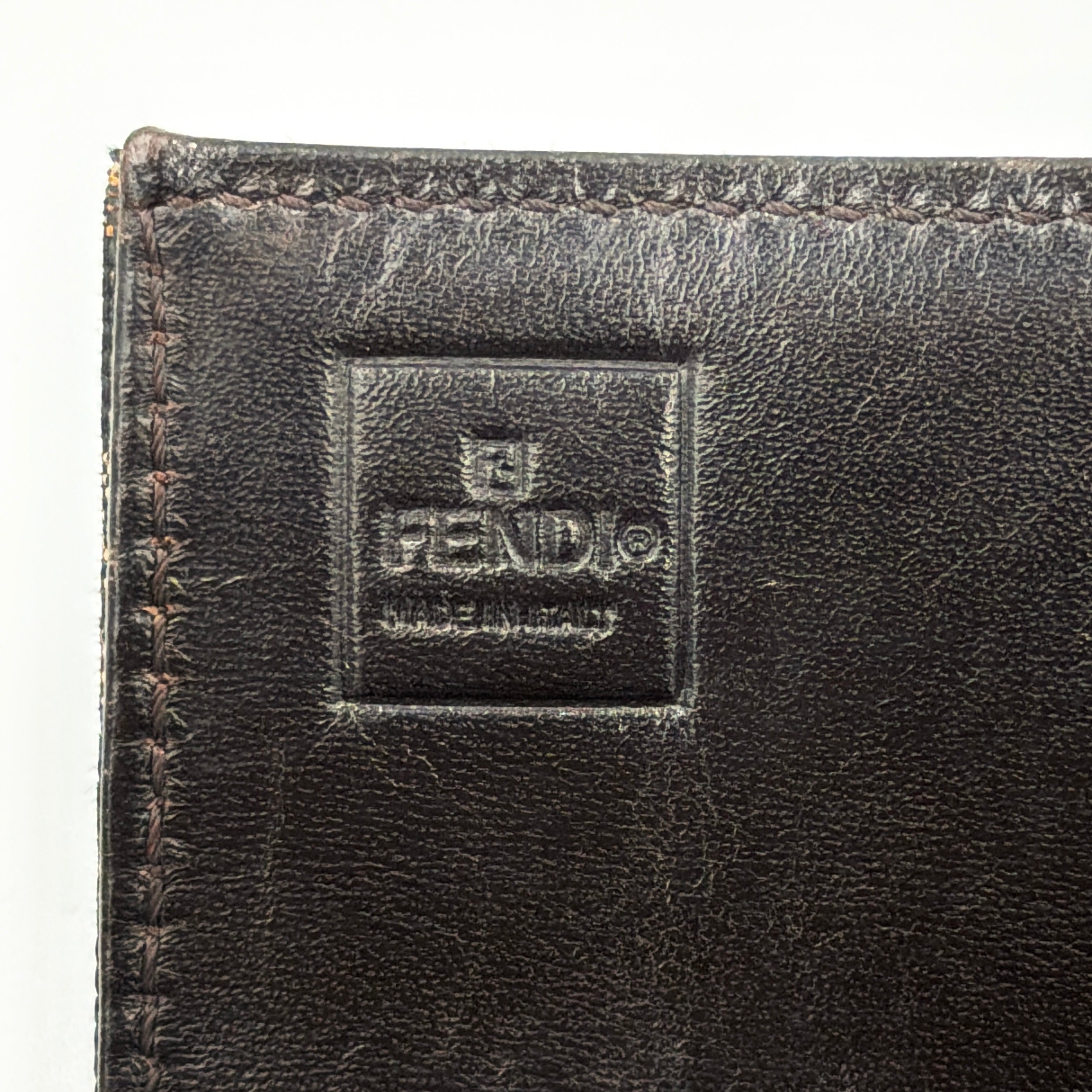 Front view of the Fendi FF Zucca long wallet in brown with signature monogram canvas and silver logo buckle.