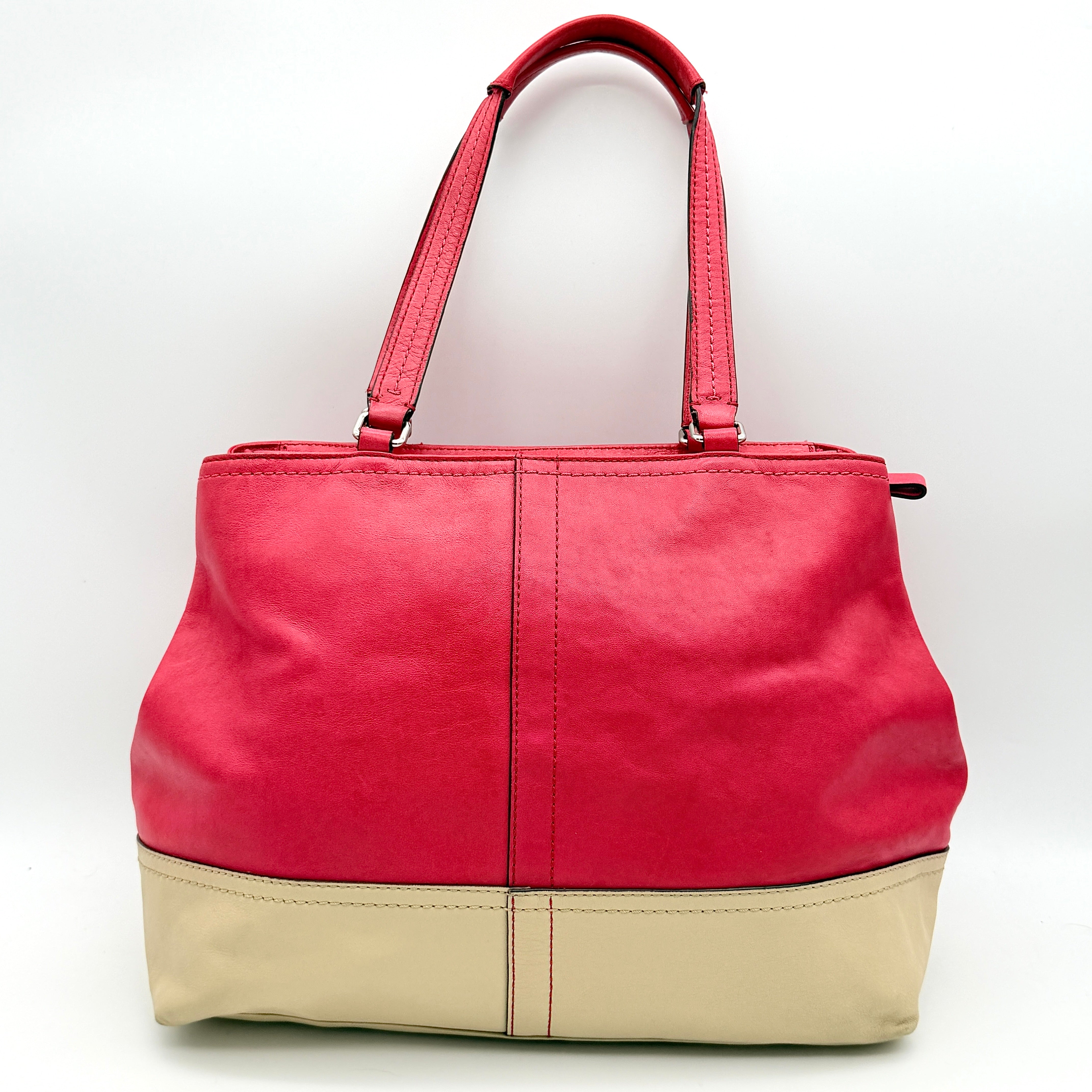 Coach Hamptons Weekend Perforated Tote in red and cream leather with dual top handles and silver hardware.