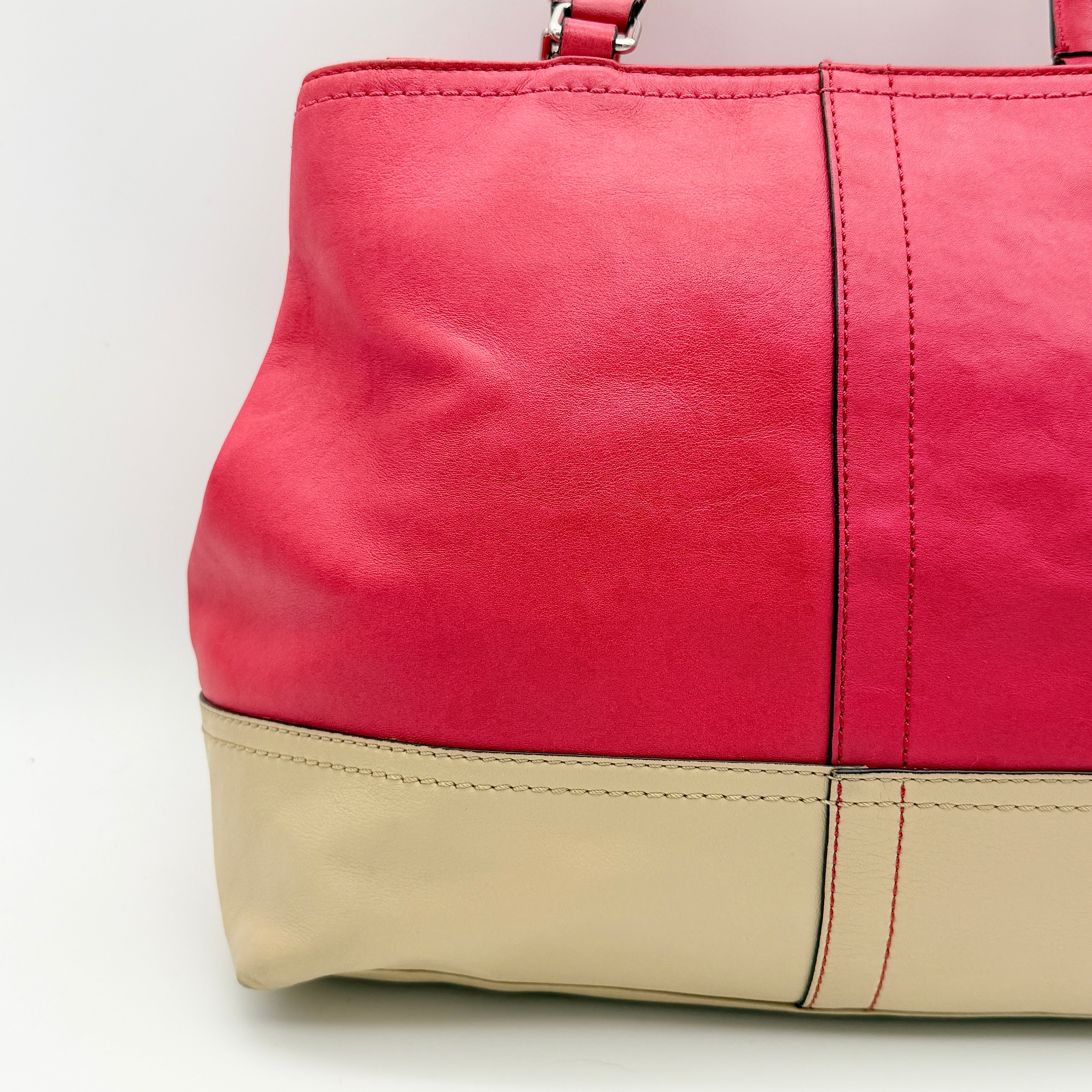 Coach Hamptons Weekend Perforated Tote in red and cream leather with dual top handles and silver hardware.