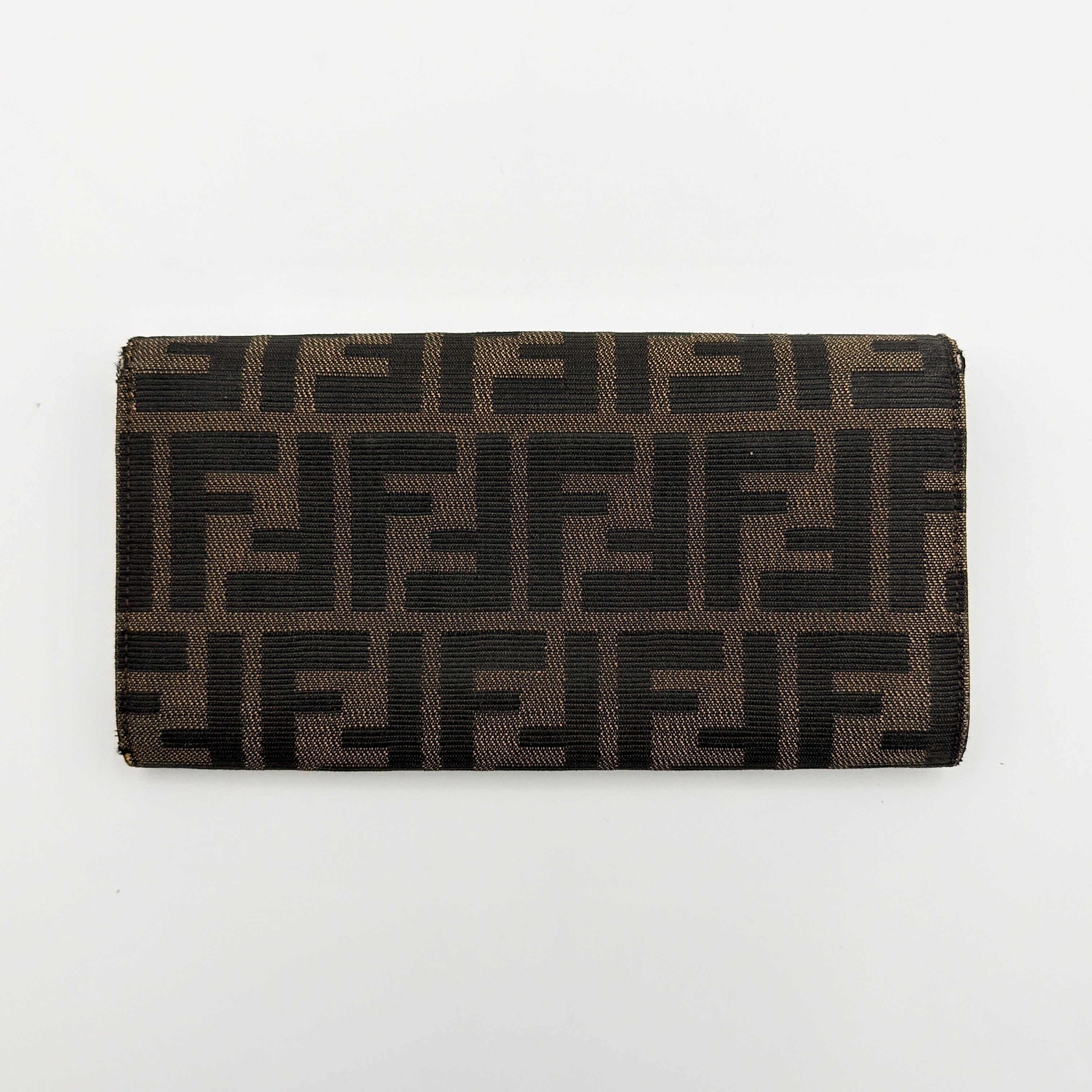 Front view of the Fendi FF Zucca long wallet in brown with signature monogram canvas and silver logo buckle.