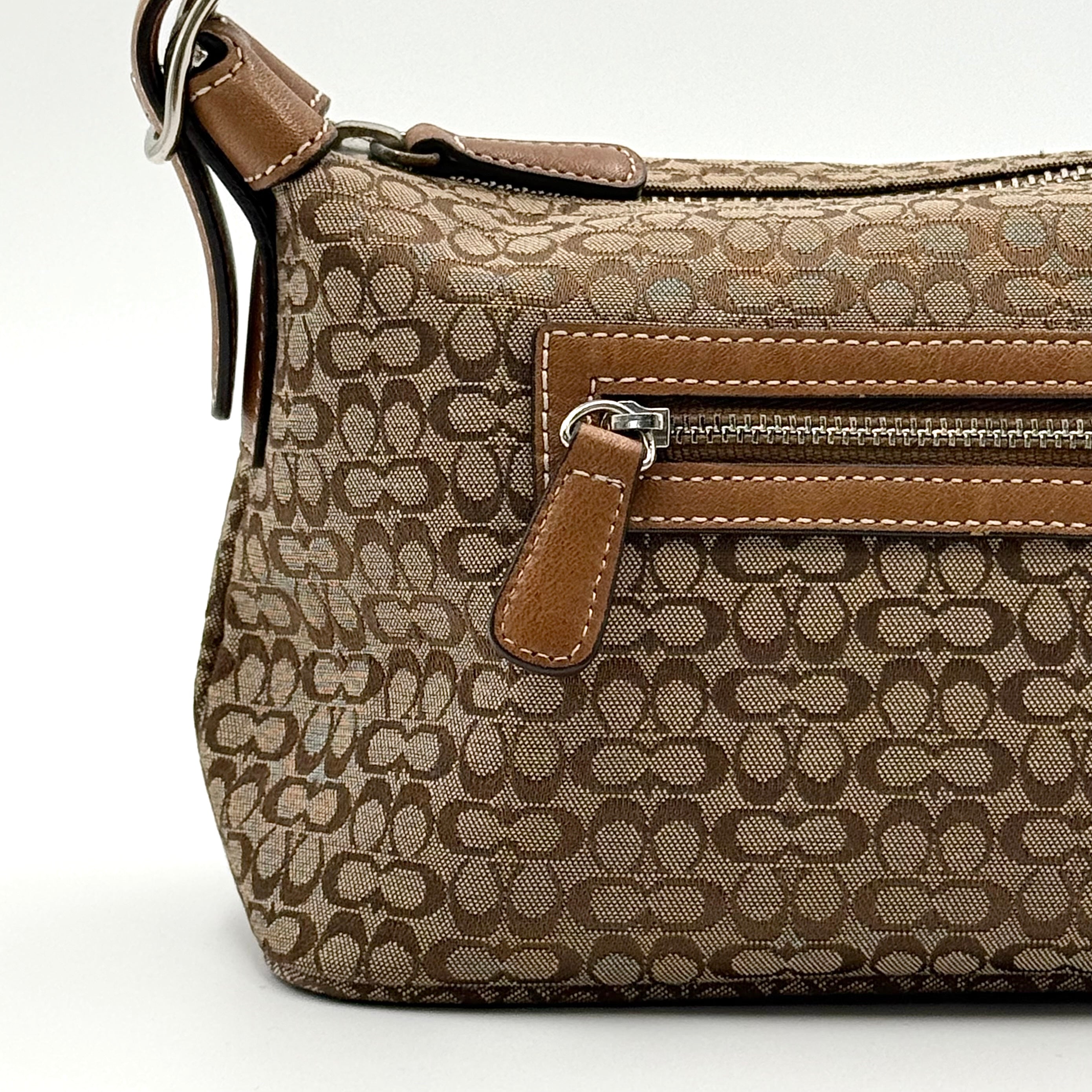 Coach signature beige jacquard hobo shoulder bag with tan leather trim and silver-tone hardware.