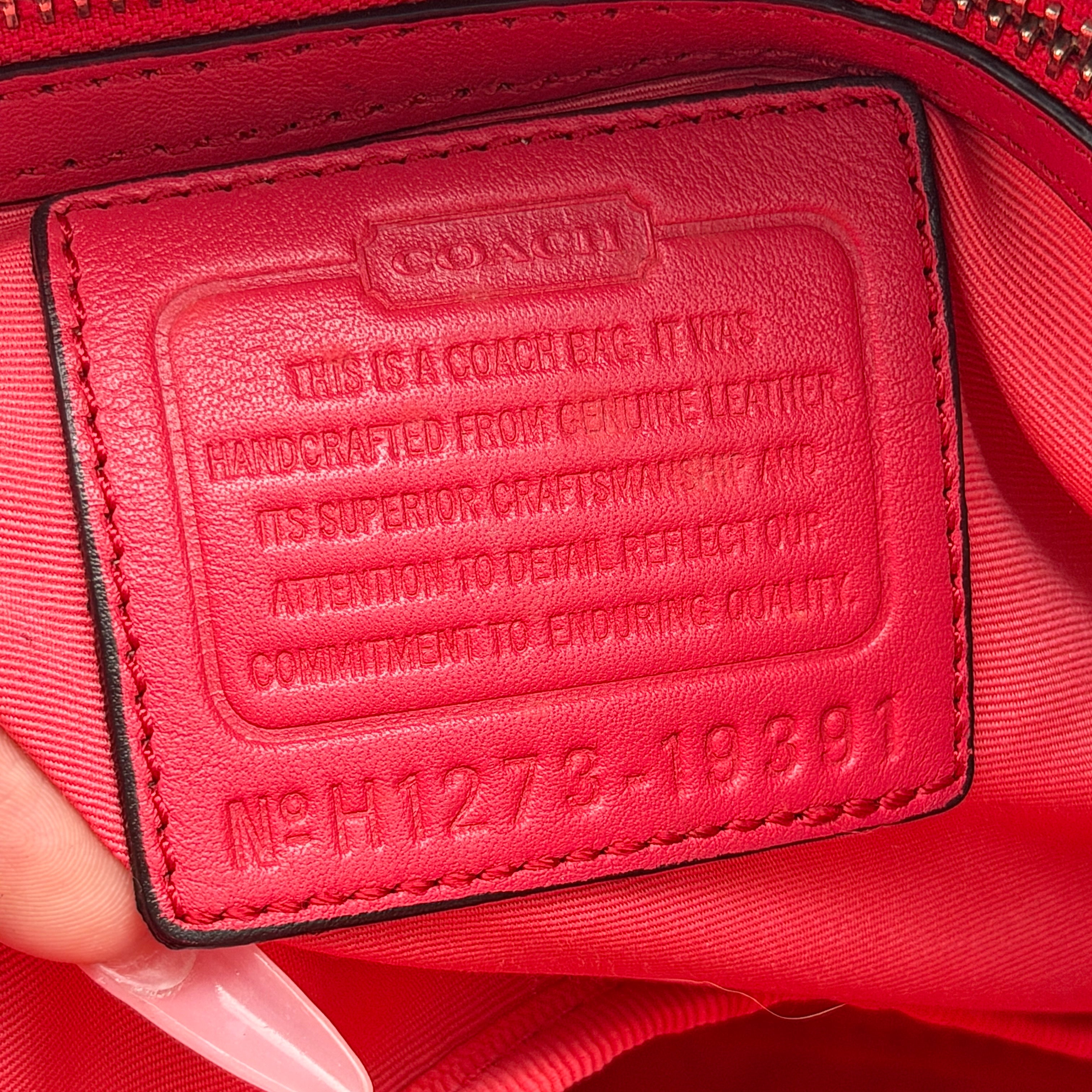 Coach Hamptons Weekend Perforated Tote in red and cream leather with dual top handles and silver hardware.
