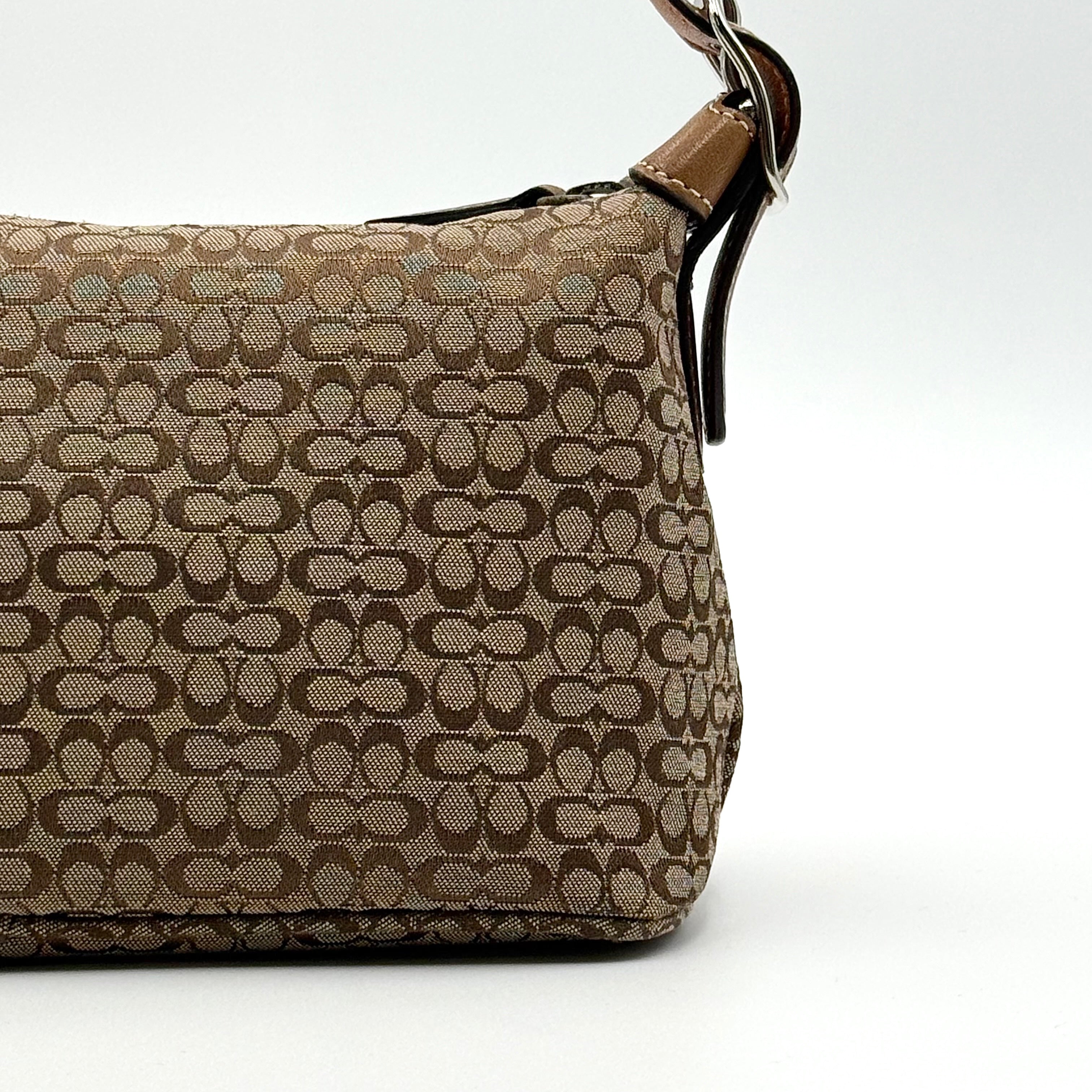 Coach signature beige jacquard hobo shoulder bag with tan leather trim and silver-tone hardware.