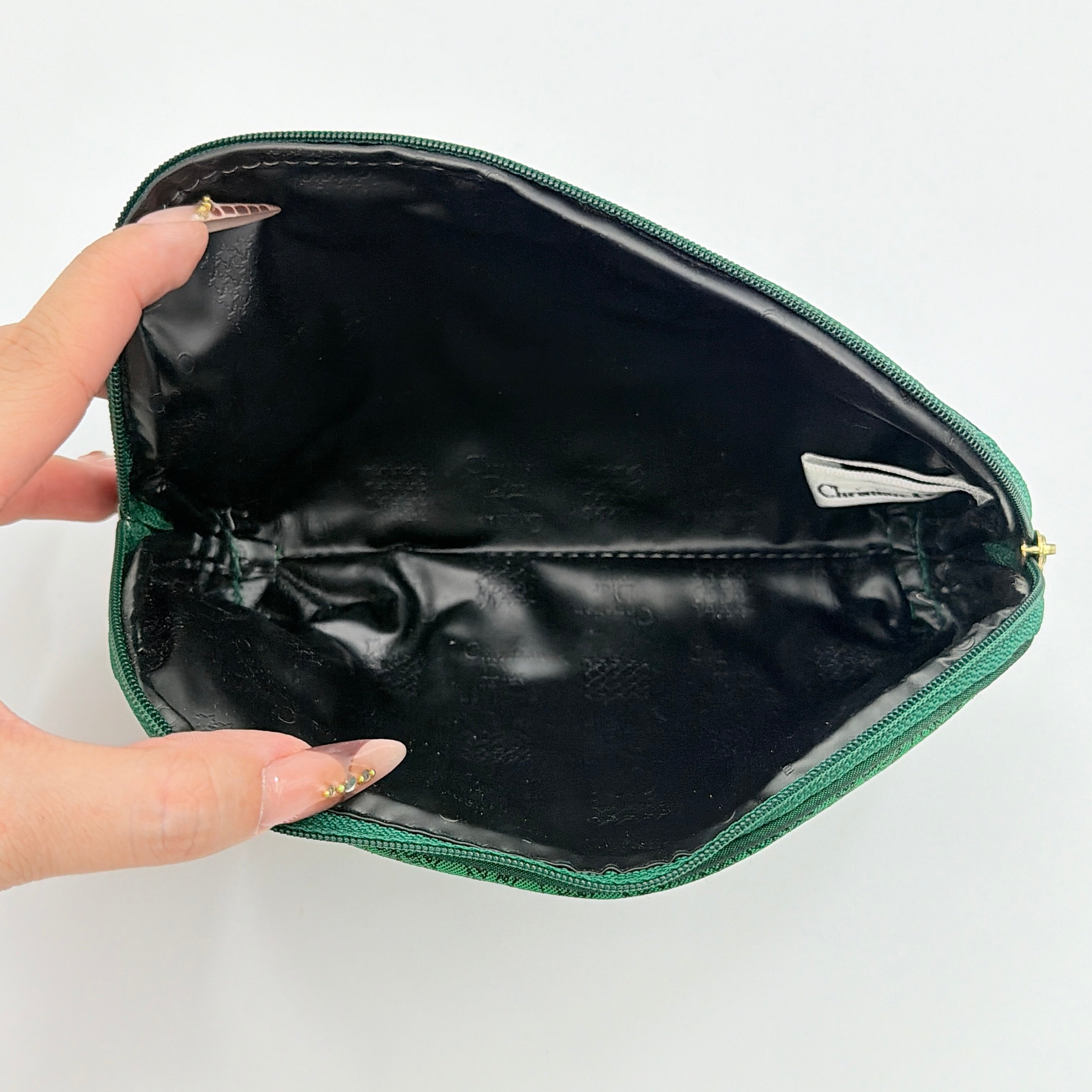 Green Christian Dior Oblique cosmetic pouch with monogram canvas and gold-tone zip, shown from the front.