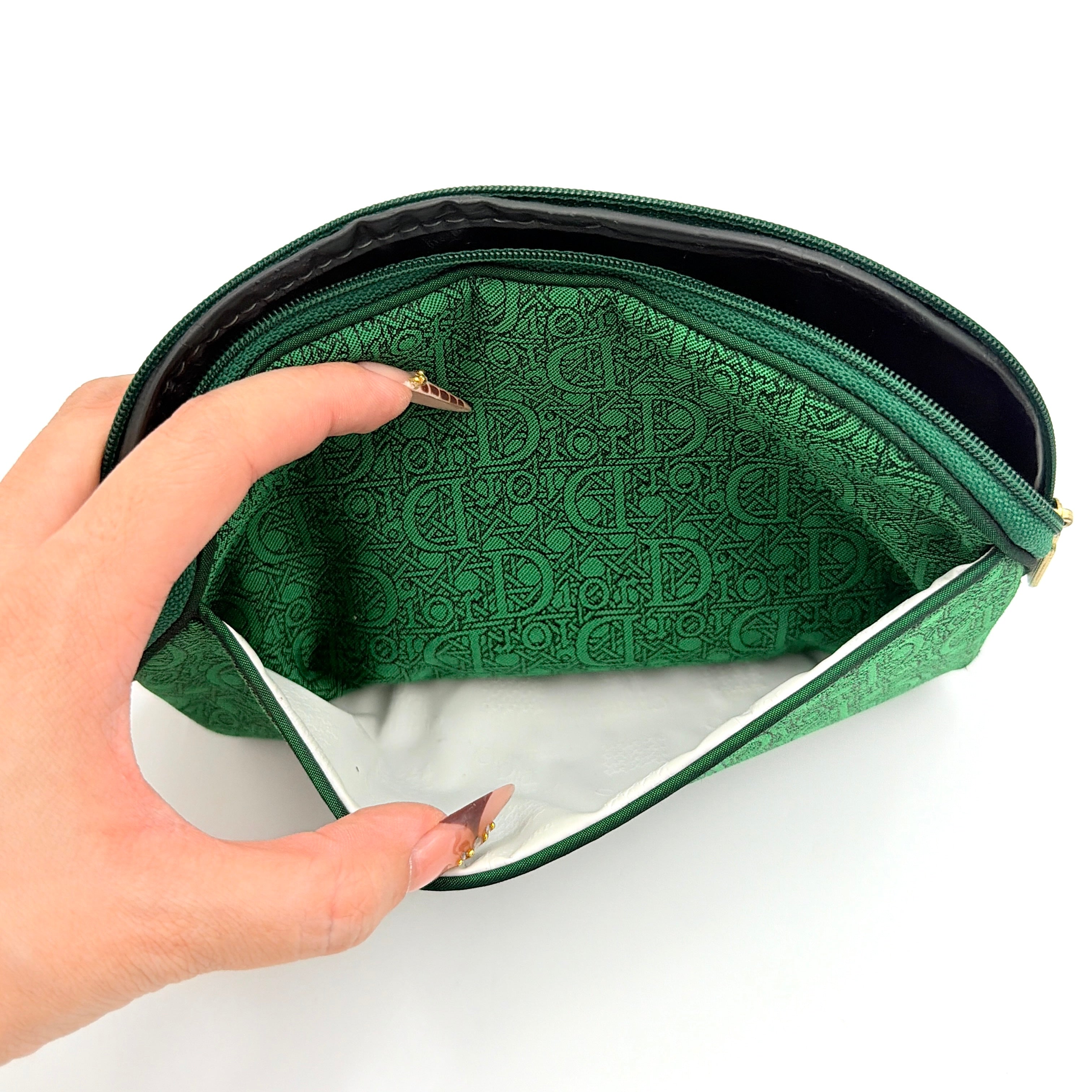Green Christian Dior Oblique cosmetic pouch with monogram canvas and gold-tone zip, shown from the front.