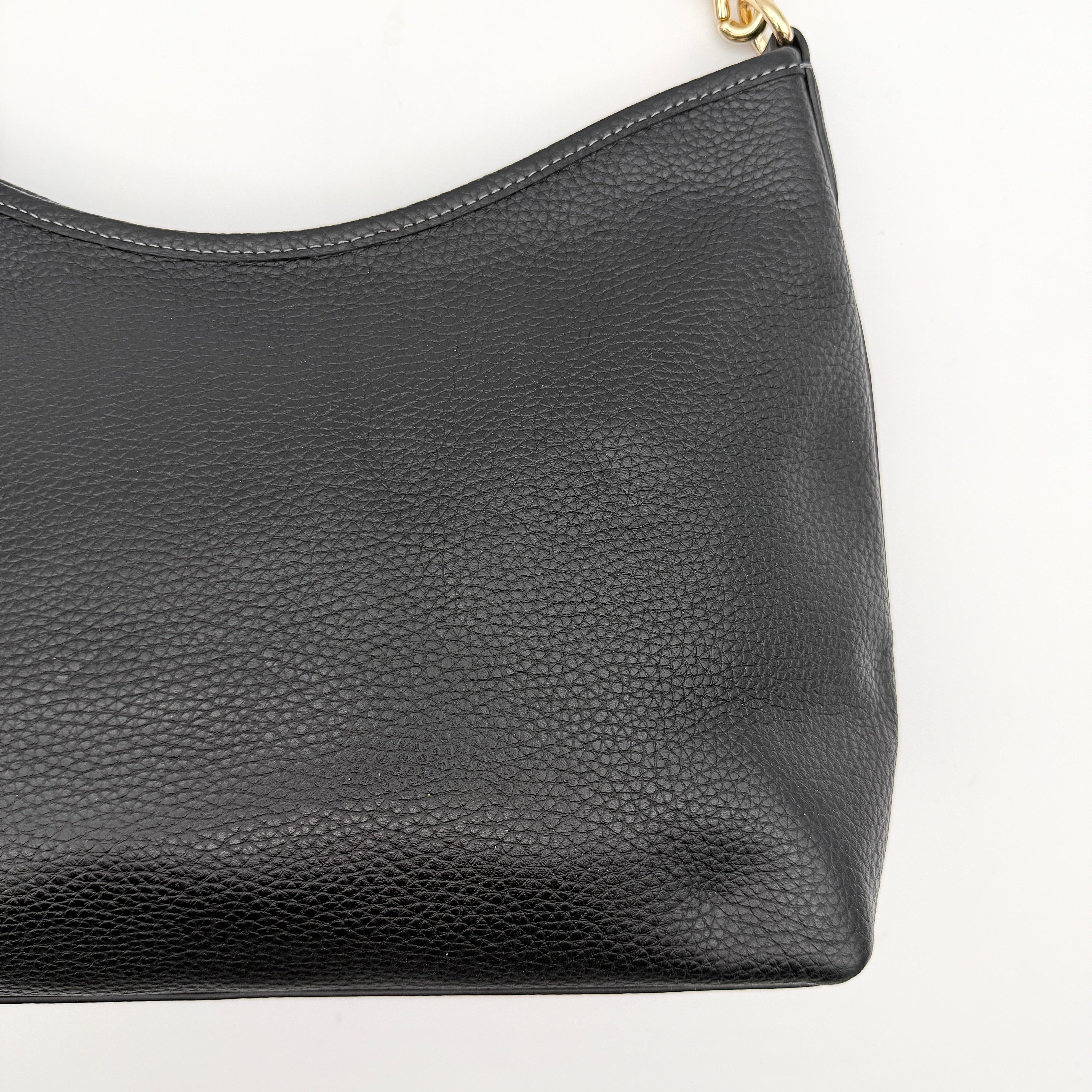 Coach Signature Laurel Shoulder Bag in black pebbled leather with gold hardware and a top zip closure.