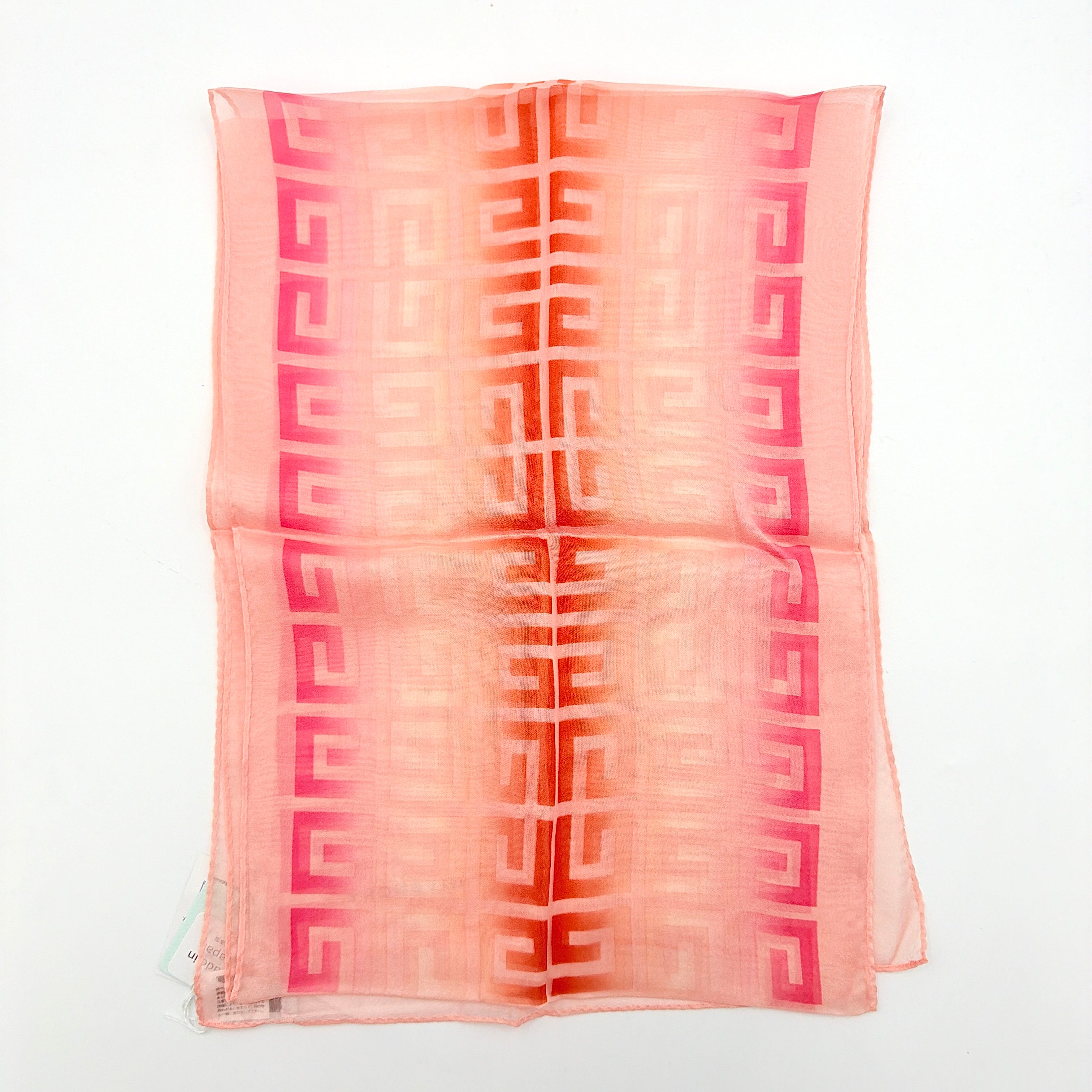 Givenchy silk scarf in pink with orange monogram pattern, showing the full length and original tags attached.
