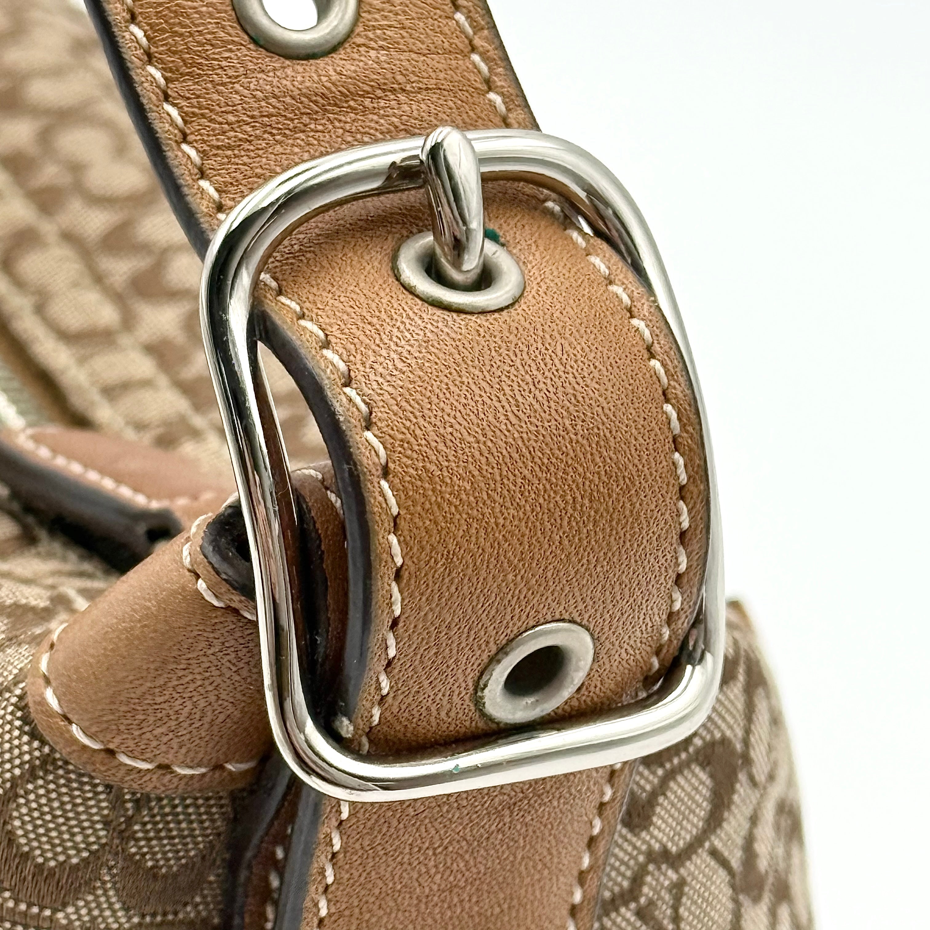 Coach signature beige jacquard hobo shoulder bag with tan leather trim and silver-tone hardware.