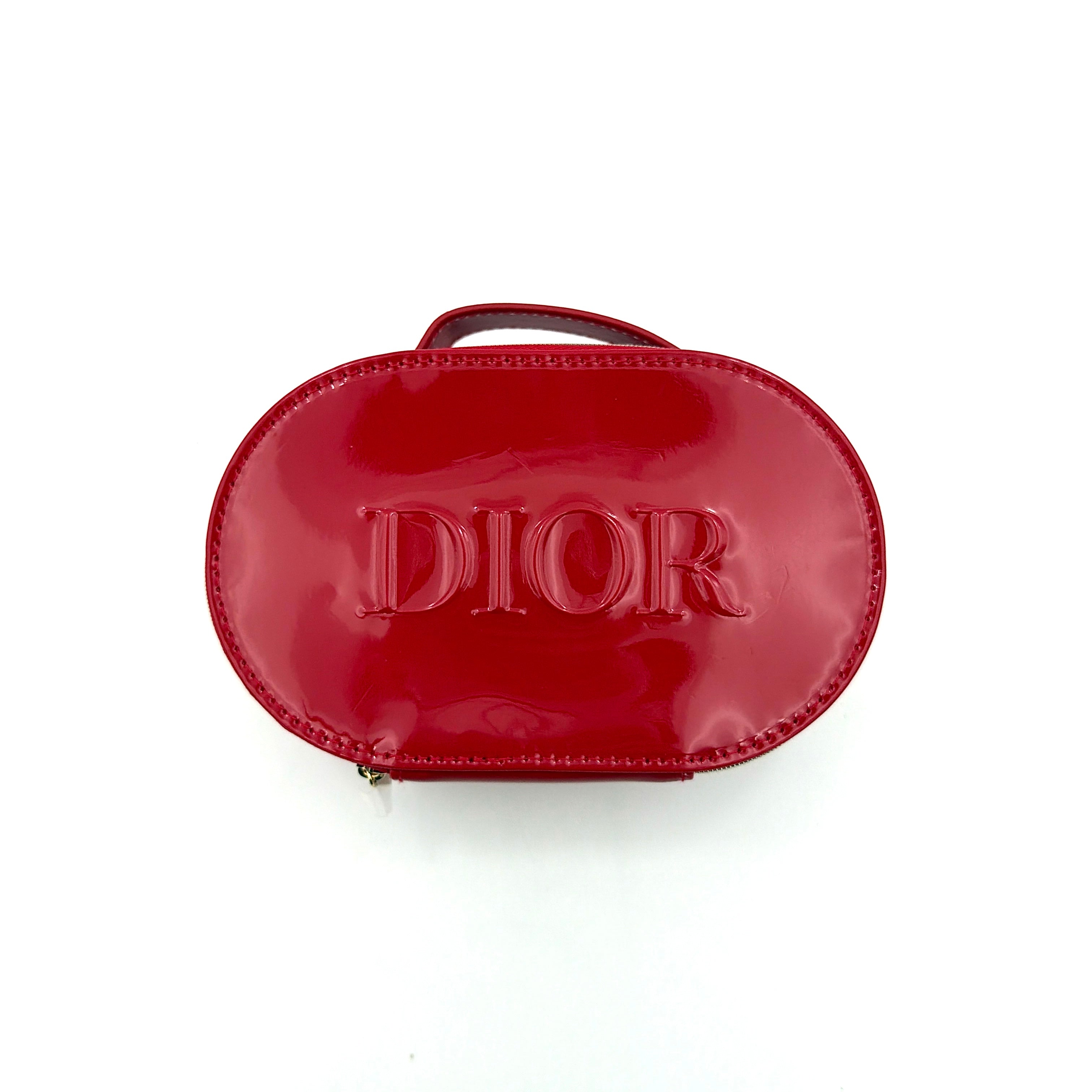 Christian Dior patent leather cosmetic pouch in glossy red with embossed DIOR logo and gold zip hardware.