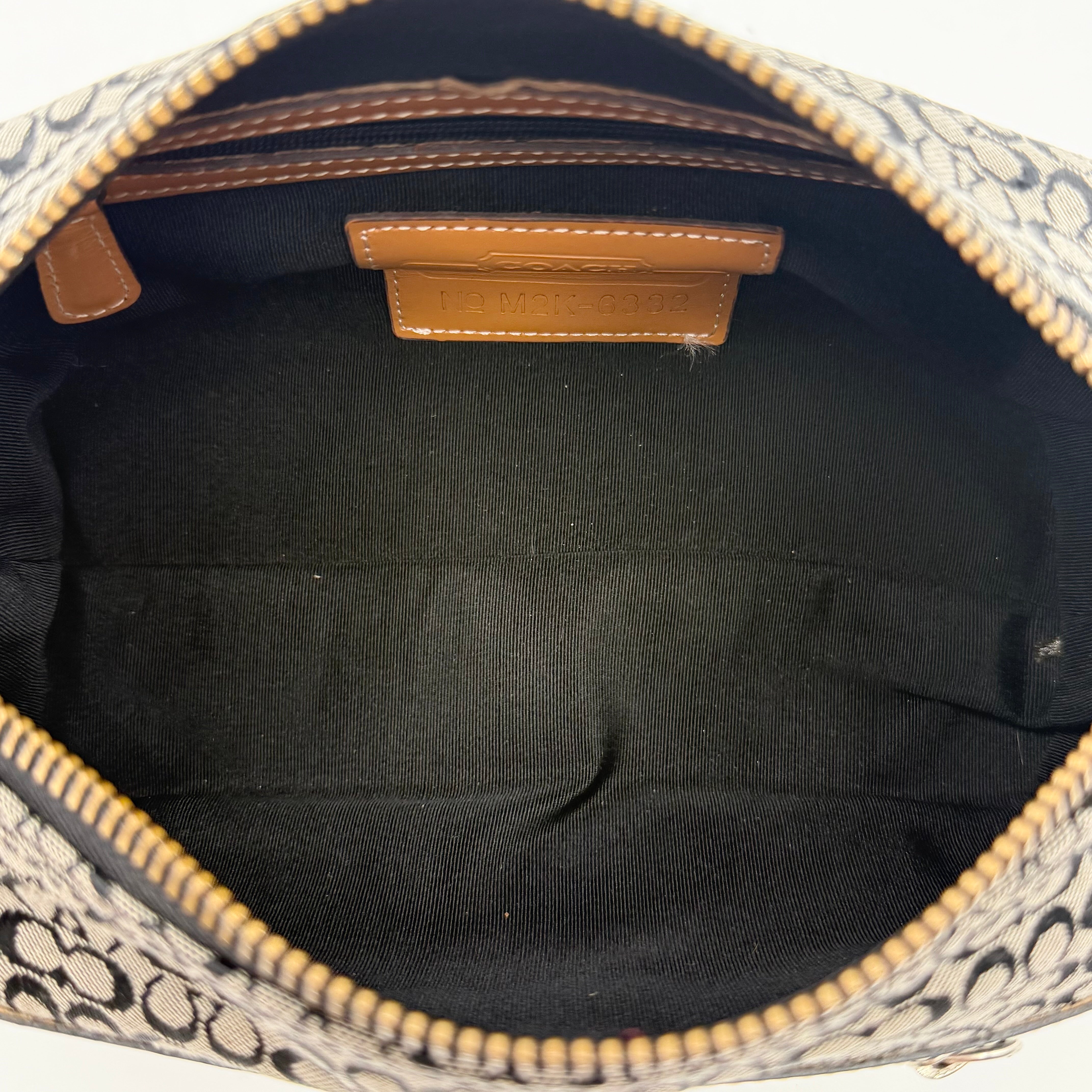 Coach Signature Hobo Shoulder Bag in grey and black canvas with leather trim and silver hardware, shown with monogram detail.
