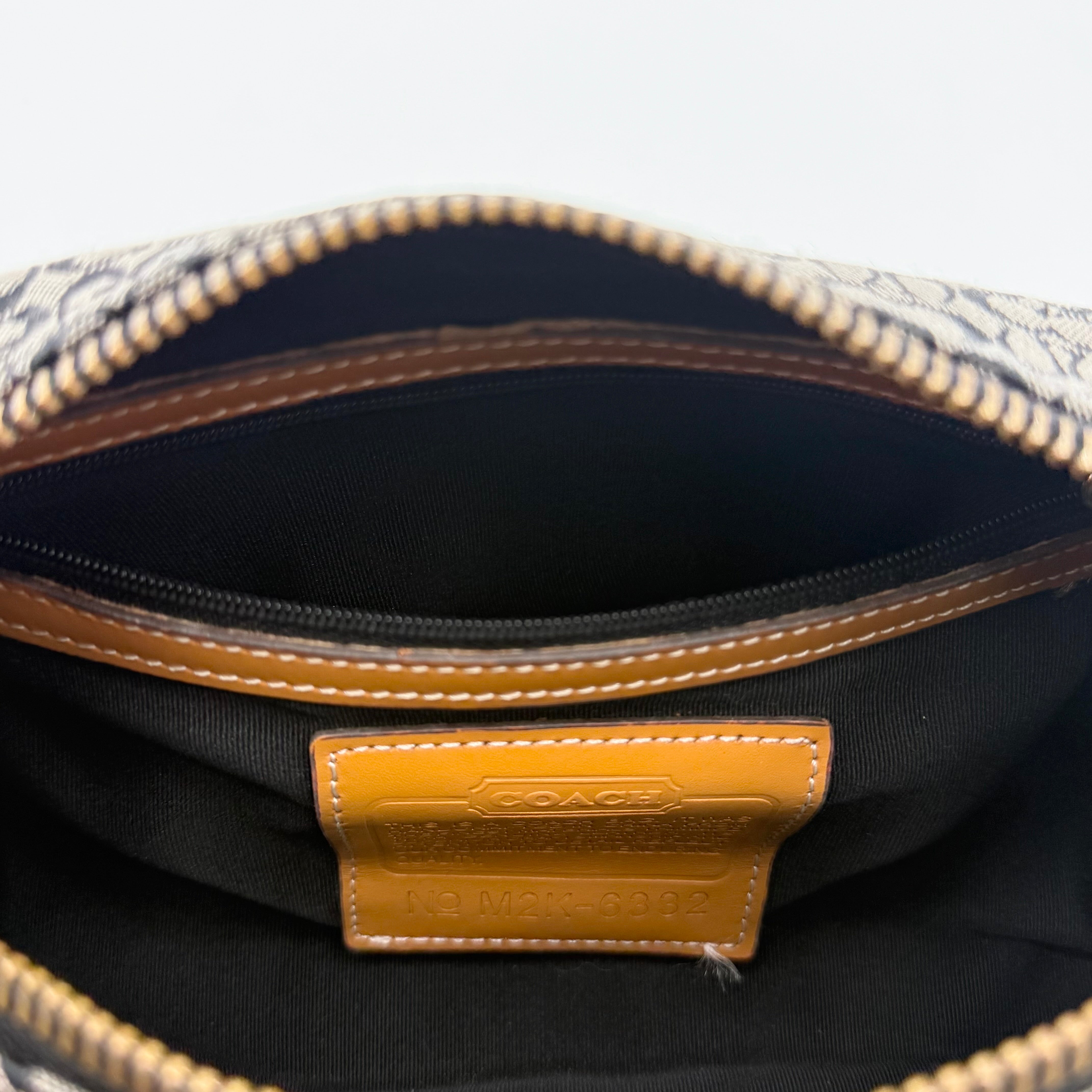 Coach Signature Hobo Shoulder Bag in grey and black canvas with leather trim and silver hardware, shown with monogram detail.