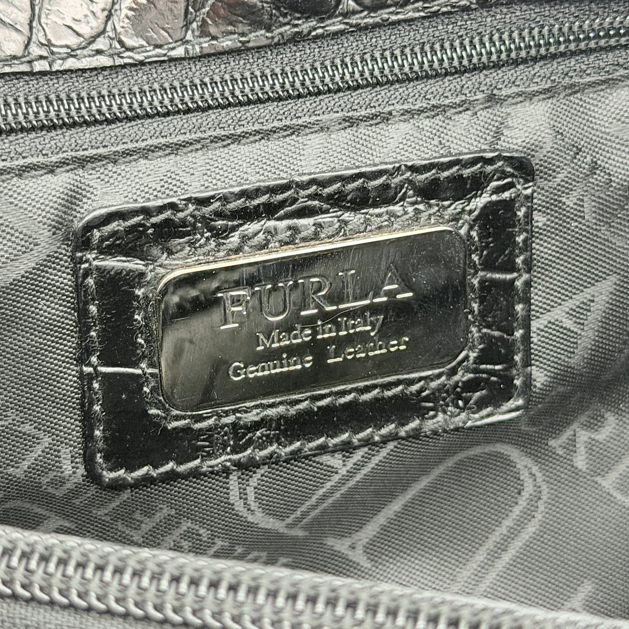 Furla croc-embossed black leather shoulder bag with suede panels and double handles, displayed against a white background.