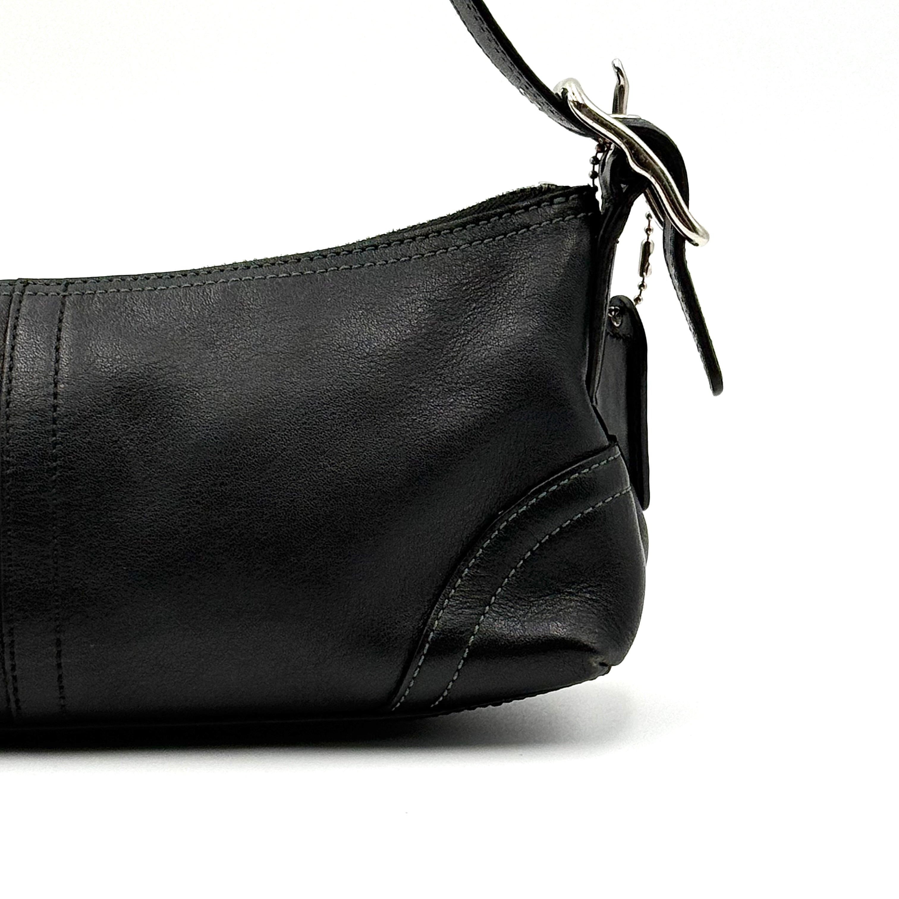 Coach Hampton Demi Baguette shoulder bag in smooth black leather with a curved top handle and silver-tone hardware.