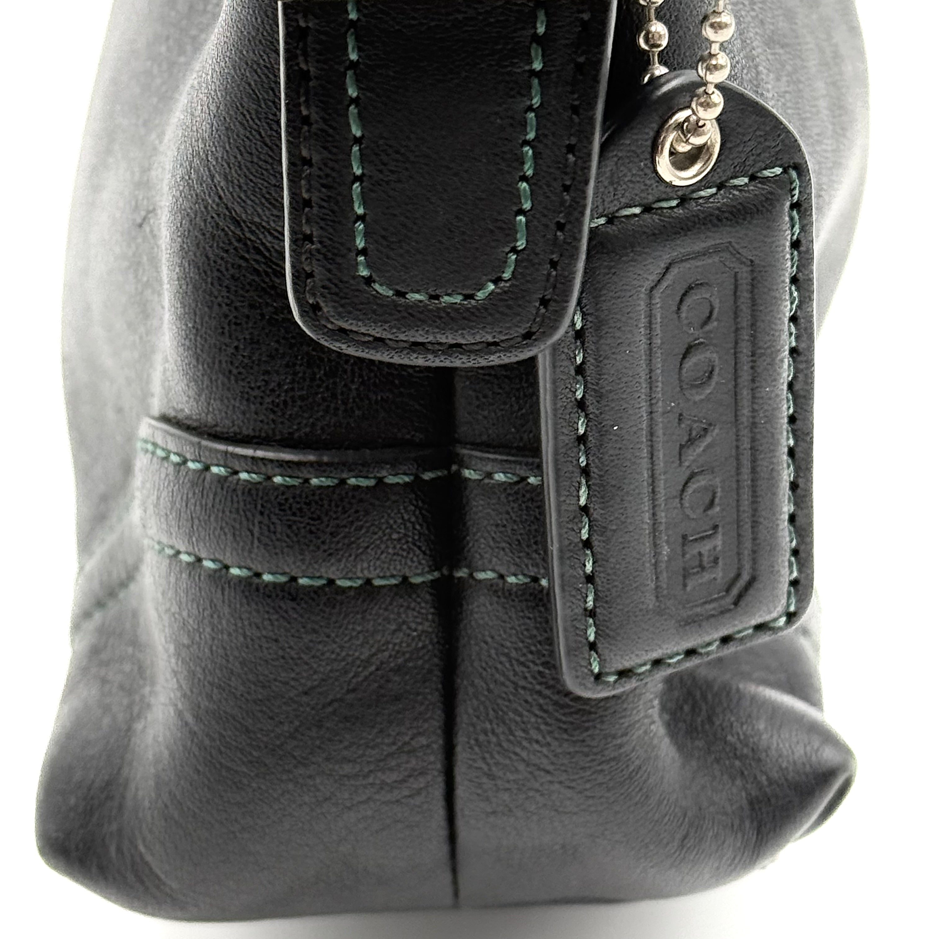 Coach Hampton Demi Baguette shoulder bag in smooth black leather with a curved top handle and silver-tone hardware.