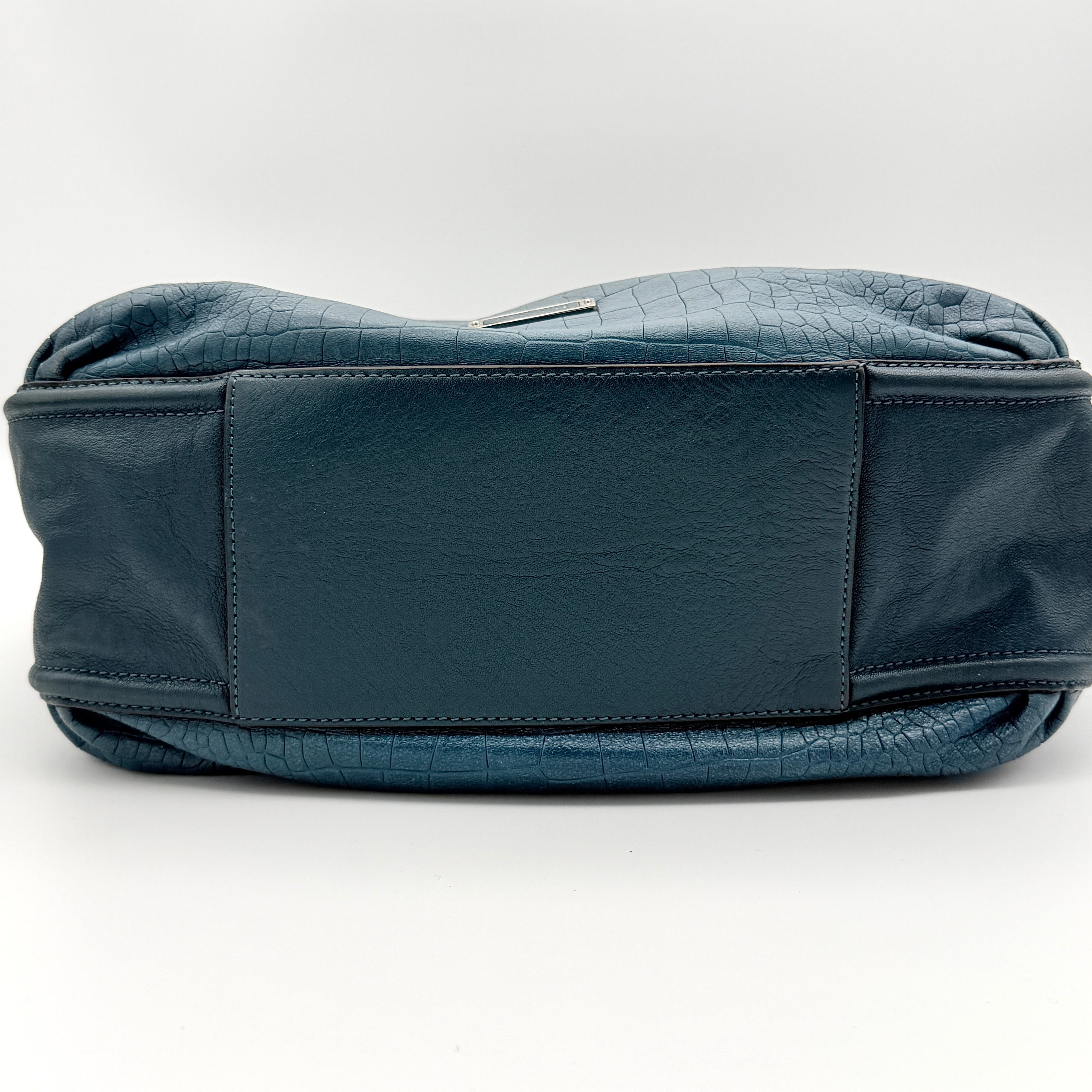 Coach Avery croc-embossed blue leather hobo shoulder bag with single handle and silver hardware against a white background.