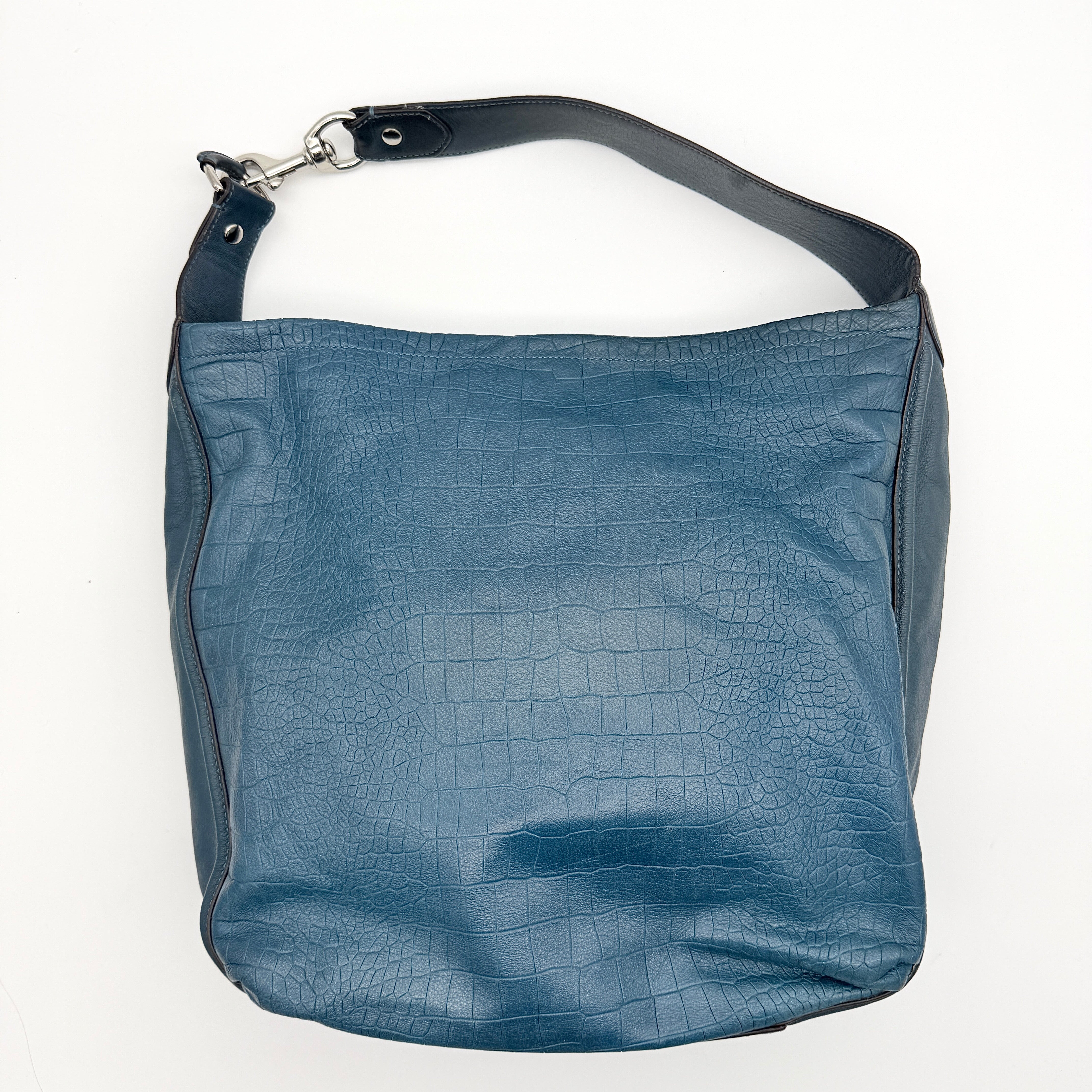 Coach Avery croc-embossed blue leather hobo shoulder bag with single handle and silver hardware against a white background.