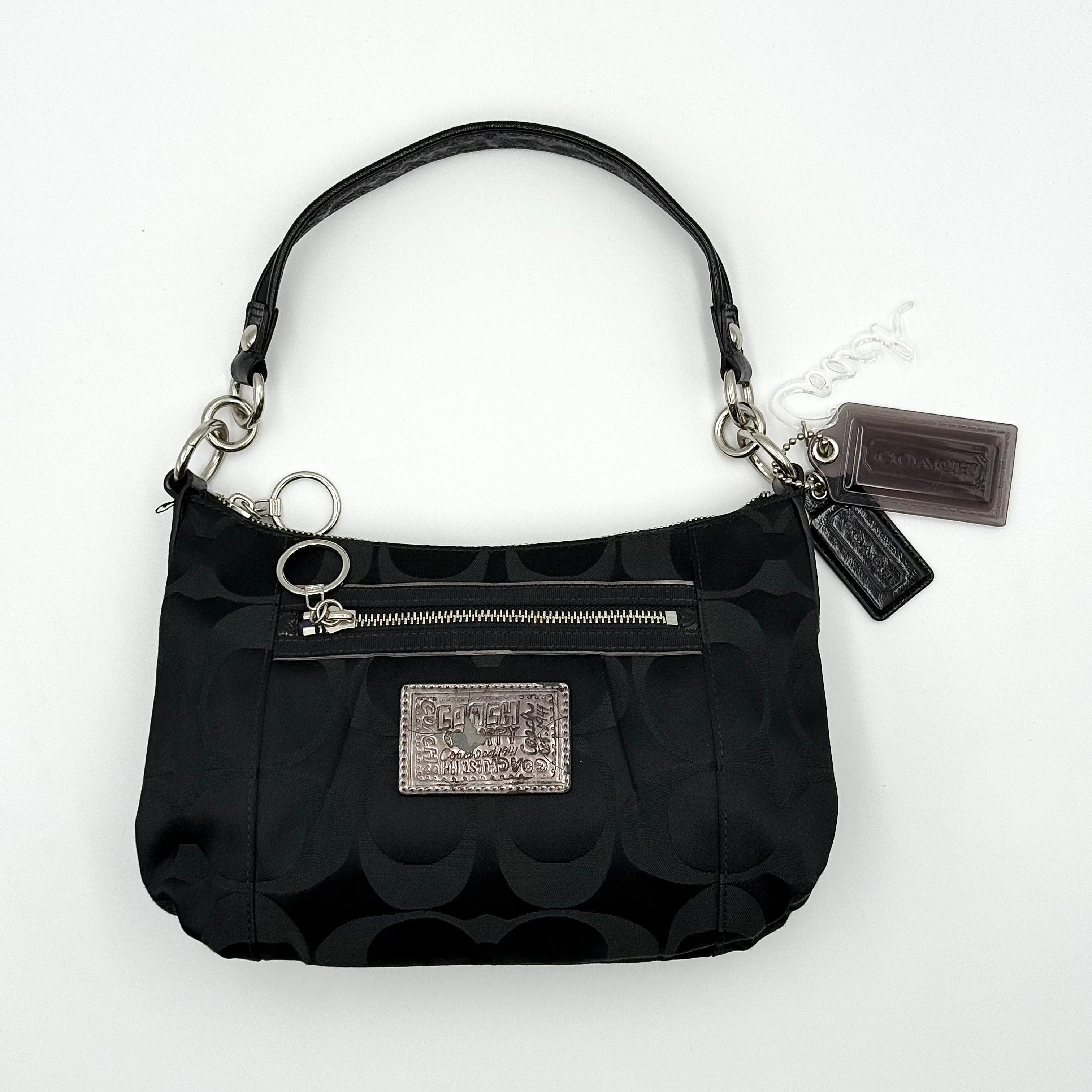 Coach black Signature Poppy Shoulder Bag with silver hardware, Coach tags, and tonal jacquard finish on a white background.
