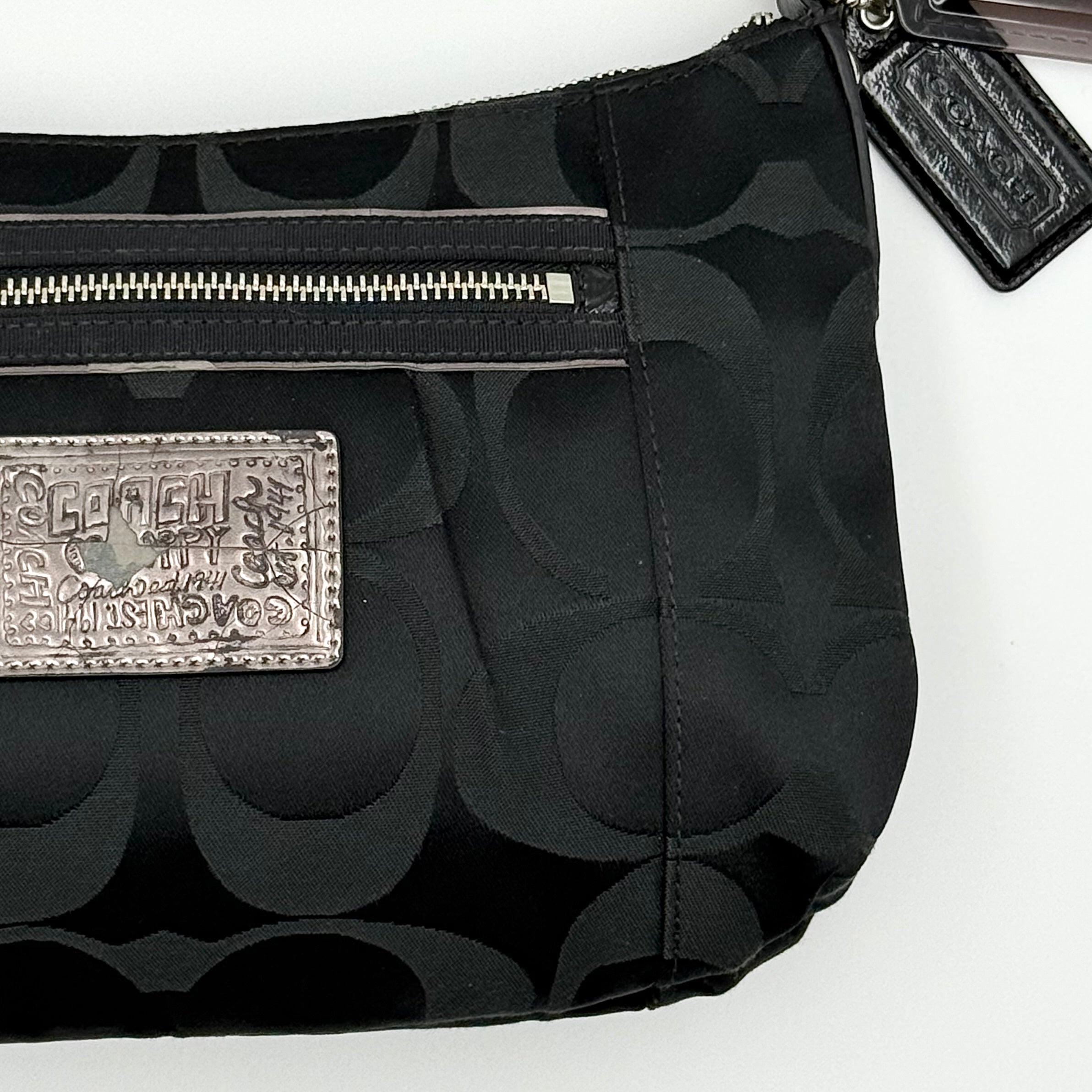 Coach black Signature Poppy Shoulder Bag with silver hardware, Coach tags, and tonal jacquard finish on a white background.