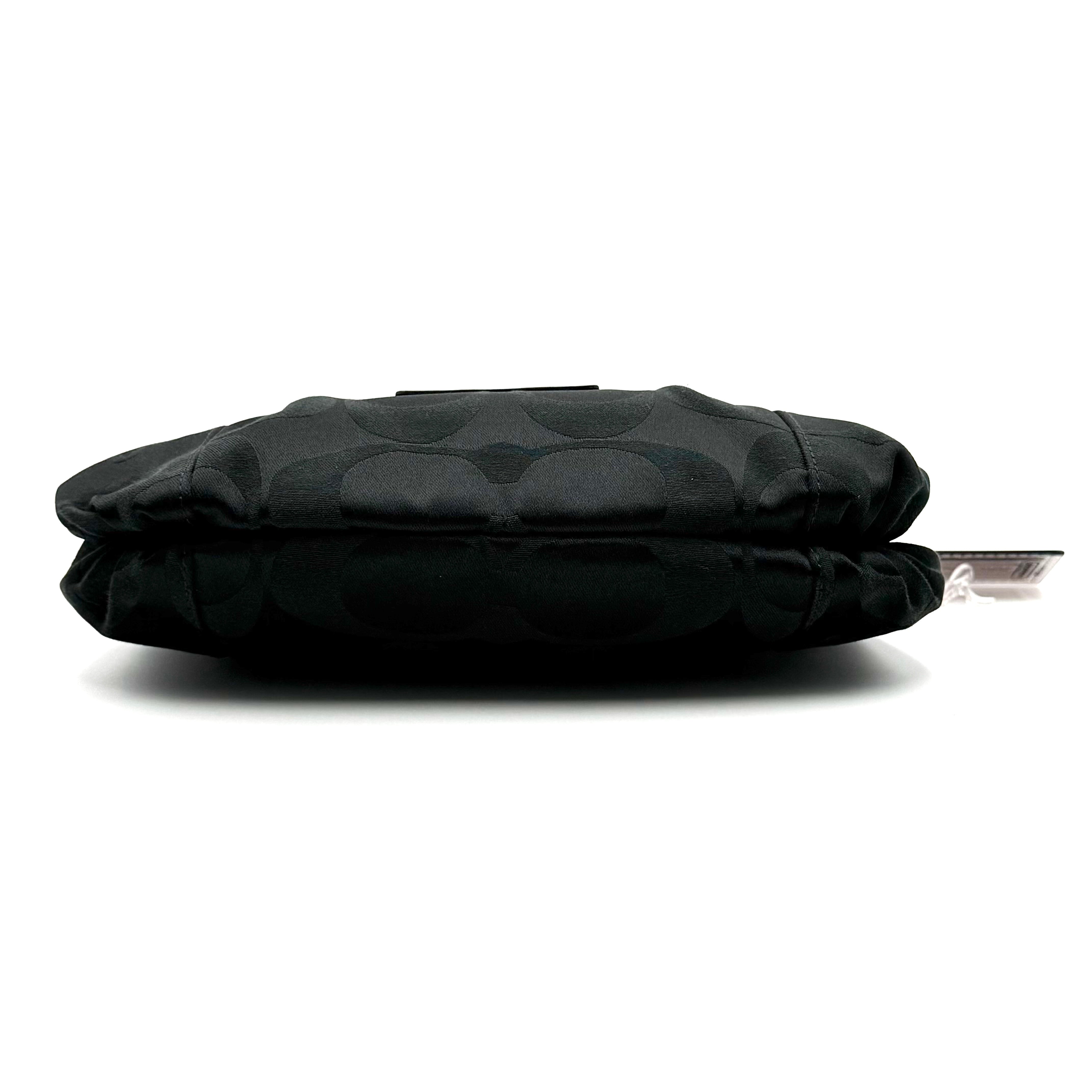 Coach black Signature Poppy Shoulder Bag with silver hardware, Coach tags, and tonal jacquard finish on a white background.