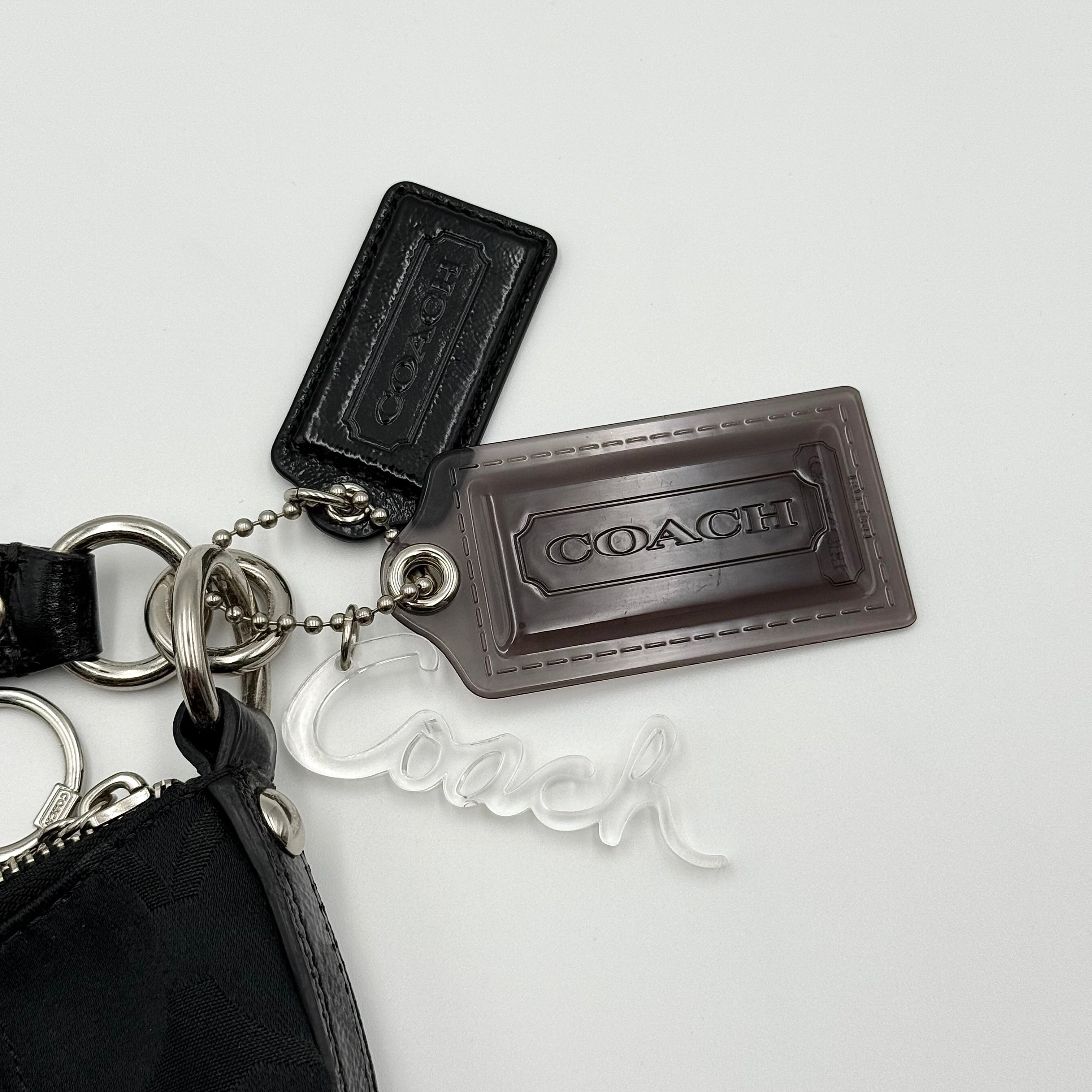 Coach black Signature Poppy Shoulder Bag with silver hardware, Coach tags, and tonal jacquard finish on a white background.
