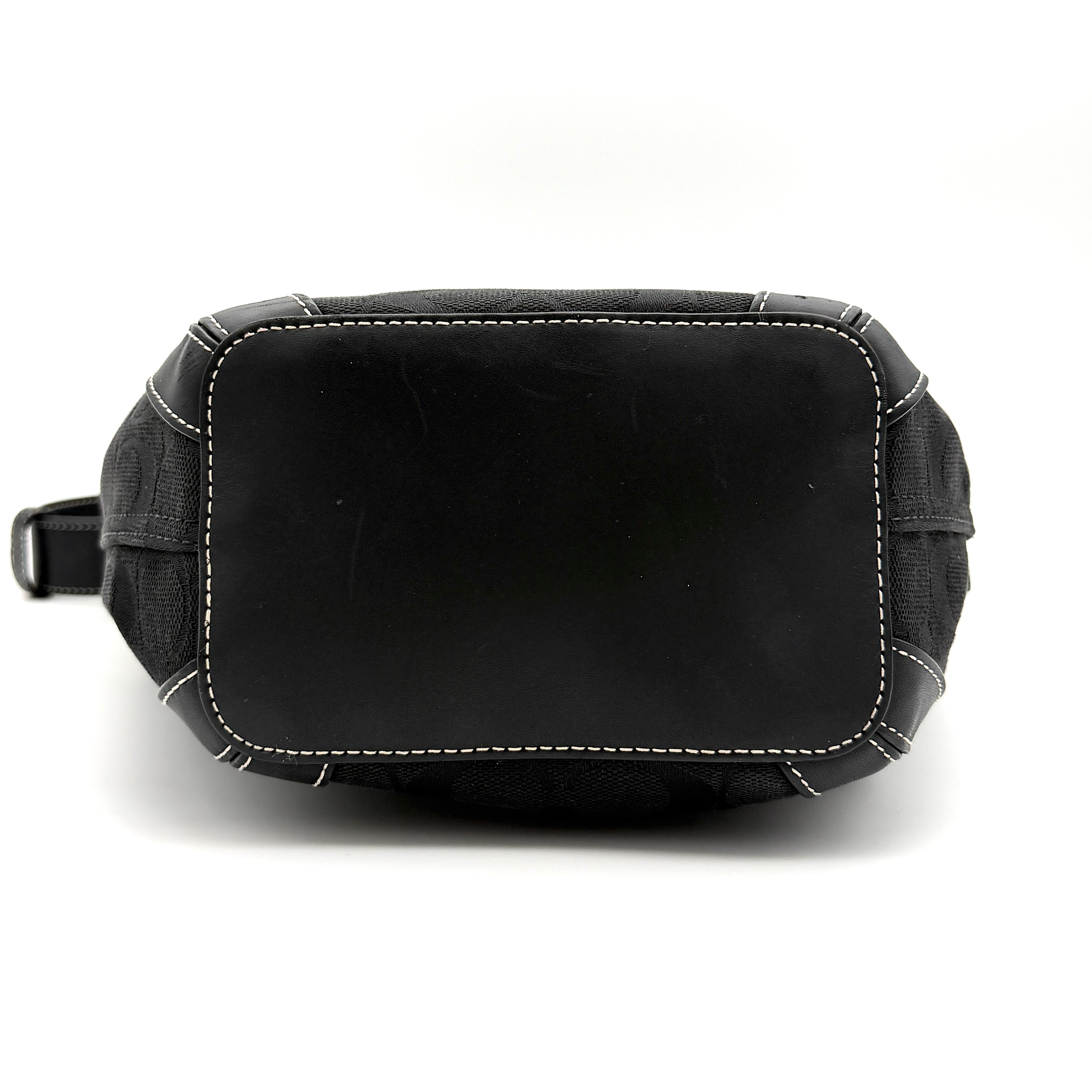 Coach black Signature Bucket Hobo bag with jacquard monogram, leather trim, and adjustable shoulder strap.