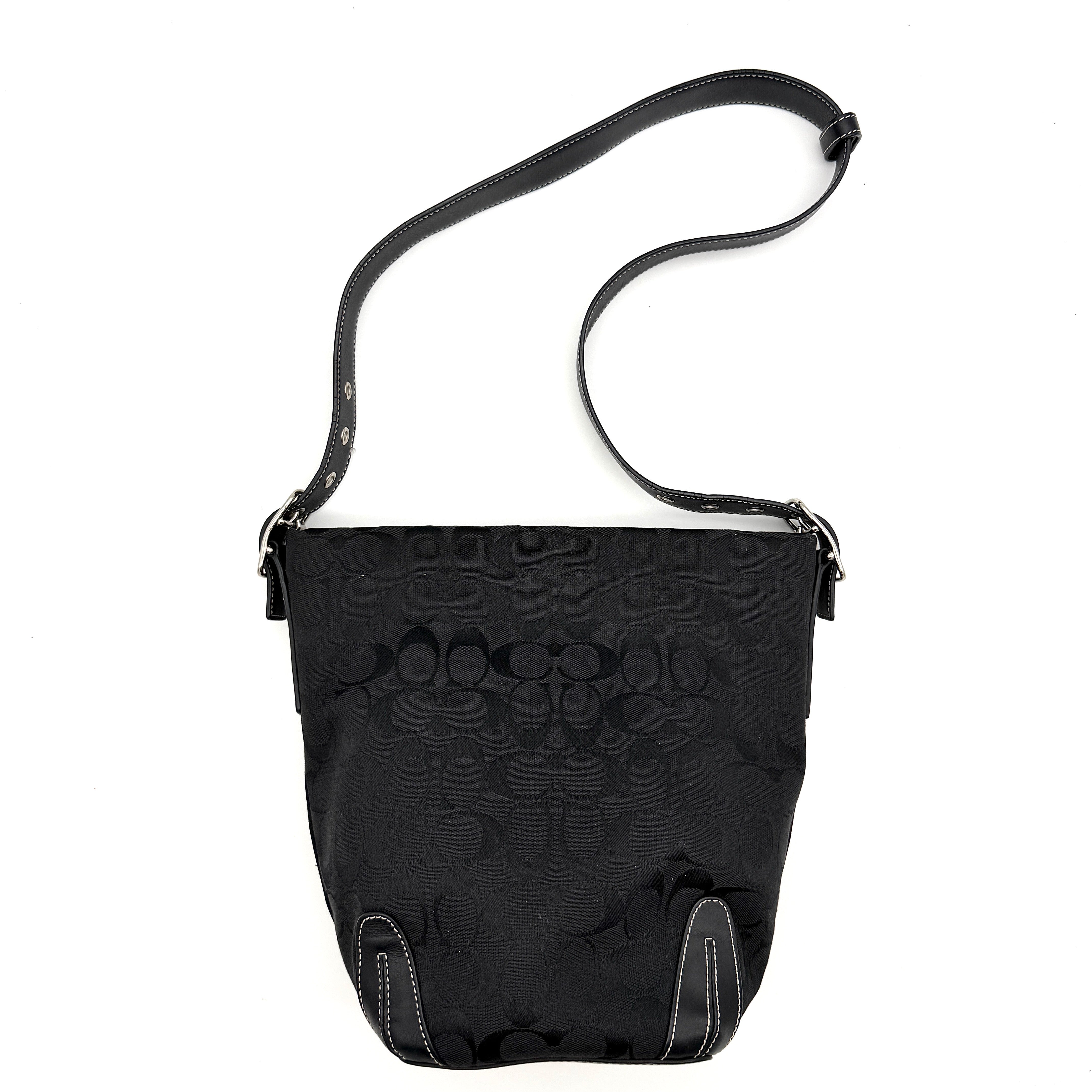 Coach black Signature Bucket Hobo bag with jacquard monogram, leather trim, and adjustable shoulder strap.