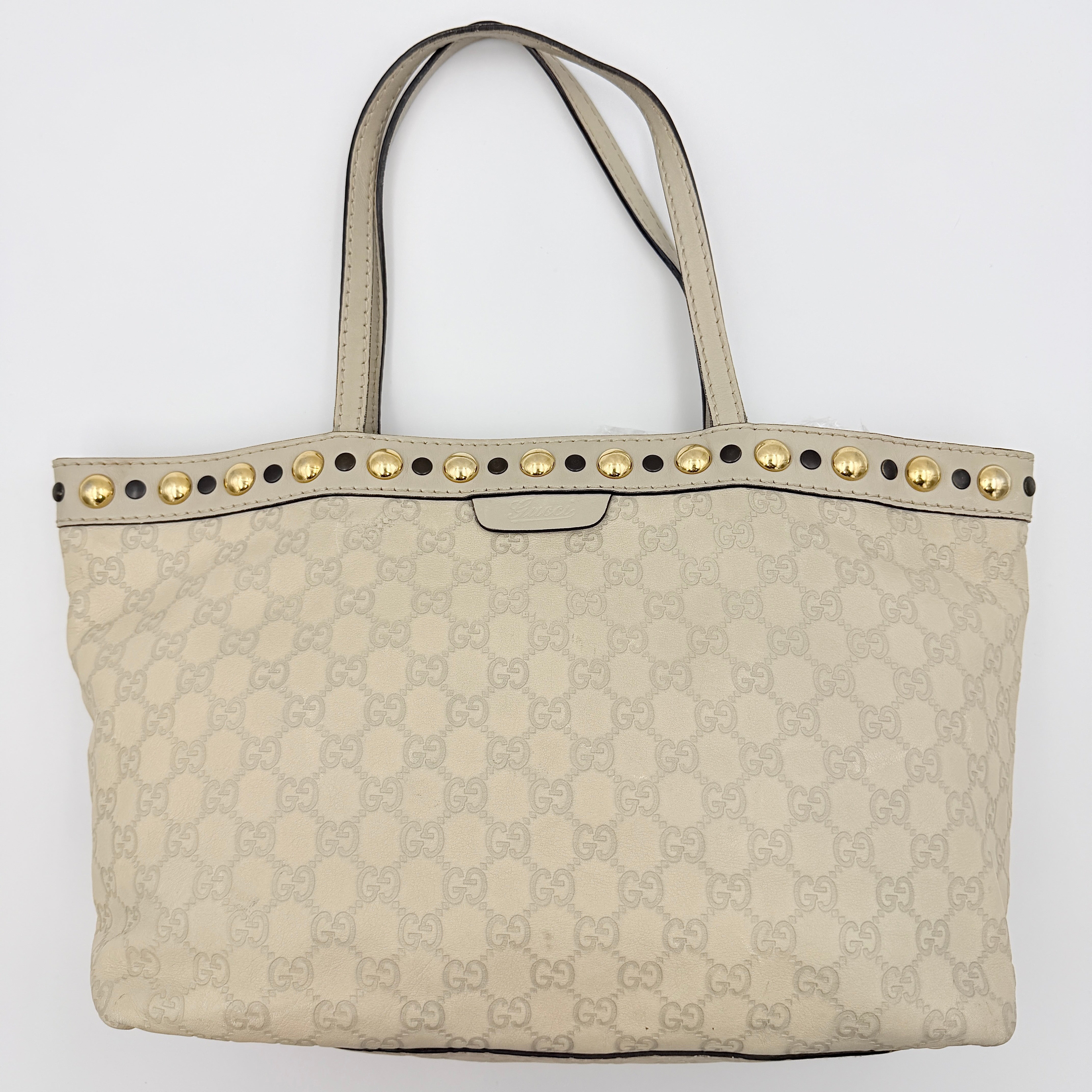 Gucci GG Monogram Babouska shoulder bag in cream canvas with gold-tone stud details and double top handles.