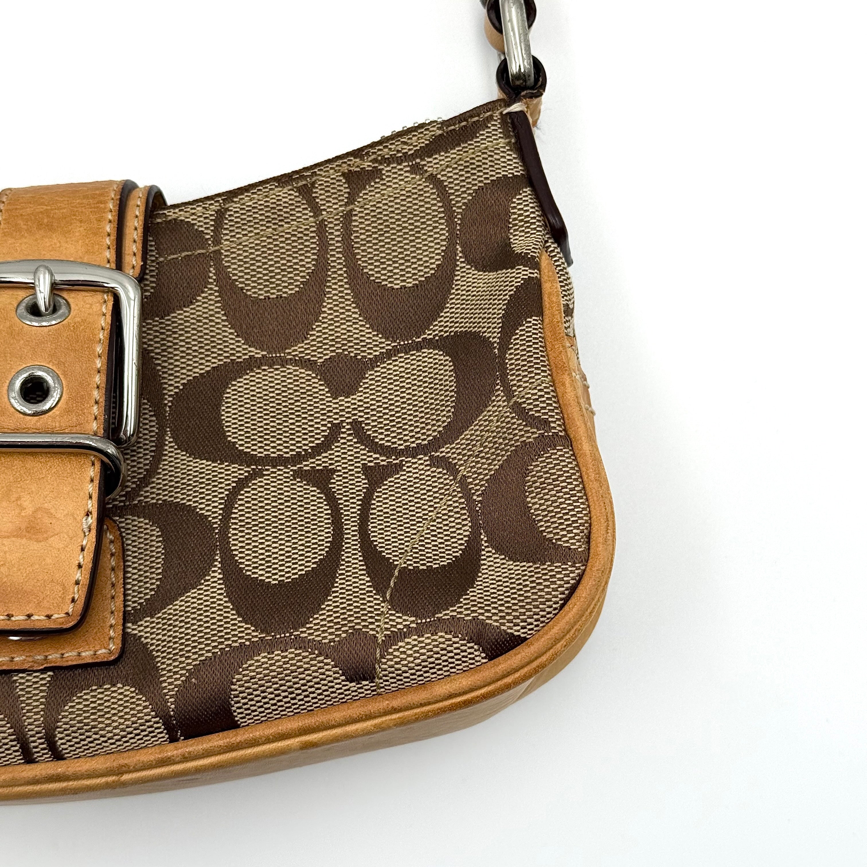 Coach Soho Demi shoulder bag in beige and tan monogram canvas with leather trim and buckle detail.