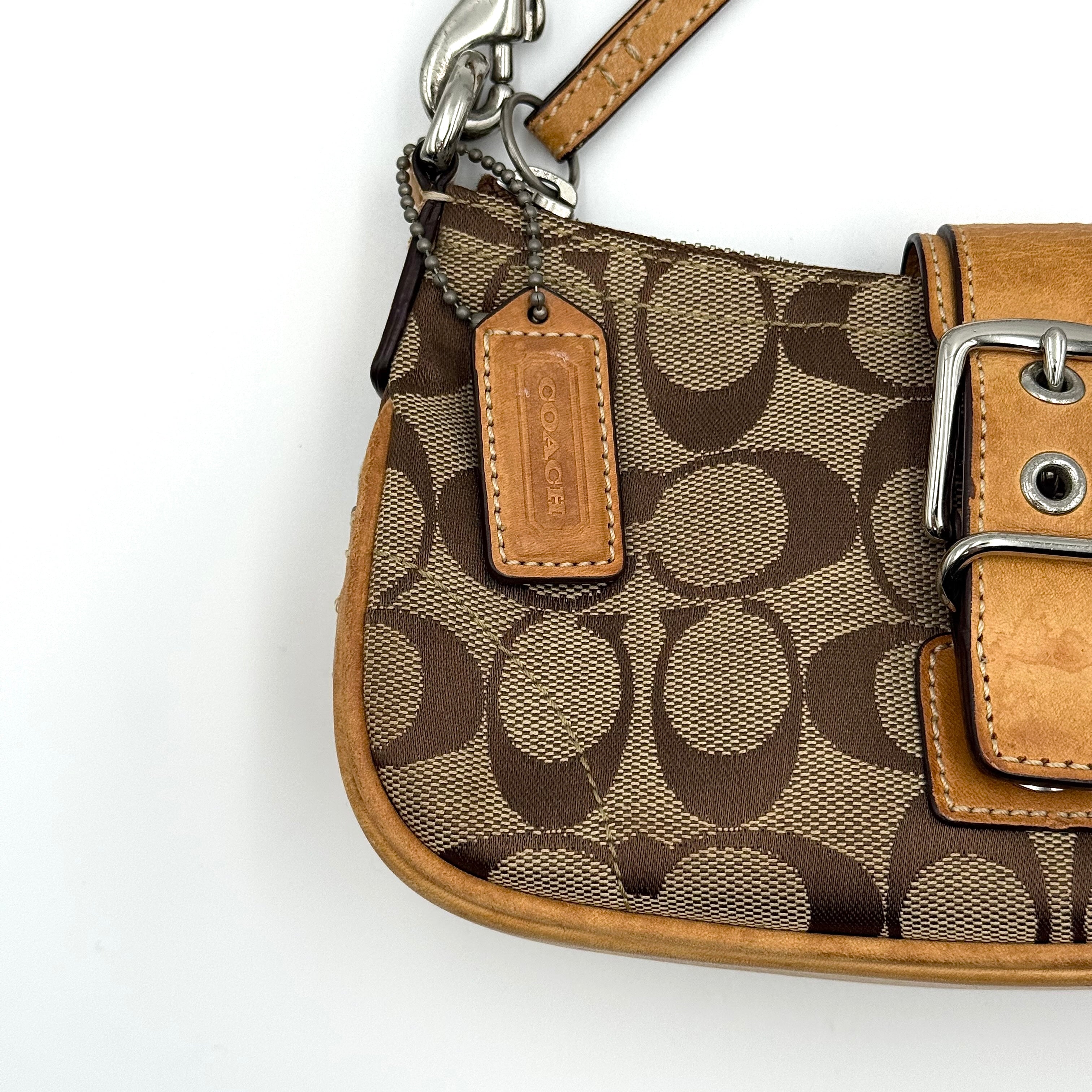 Coach Soho Demi shoulder bag in beige and tan monogram canvas with leather trim and buckle detail.