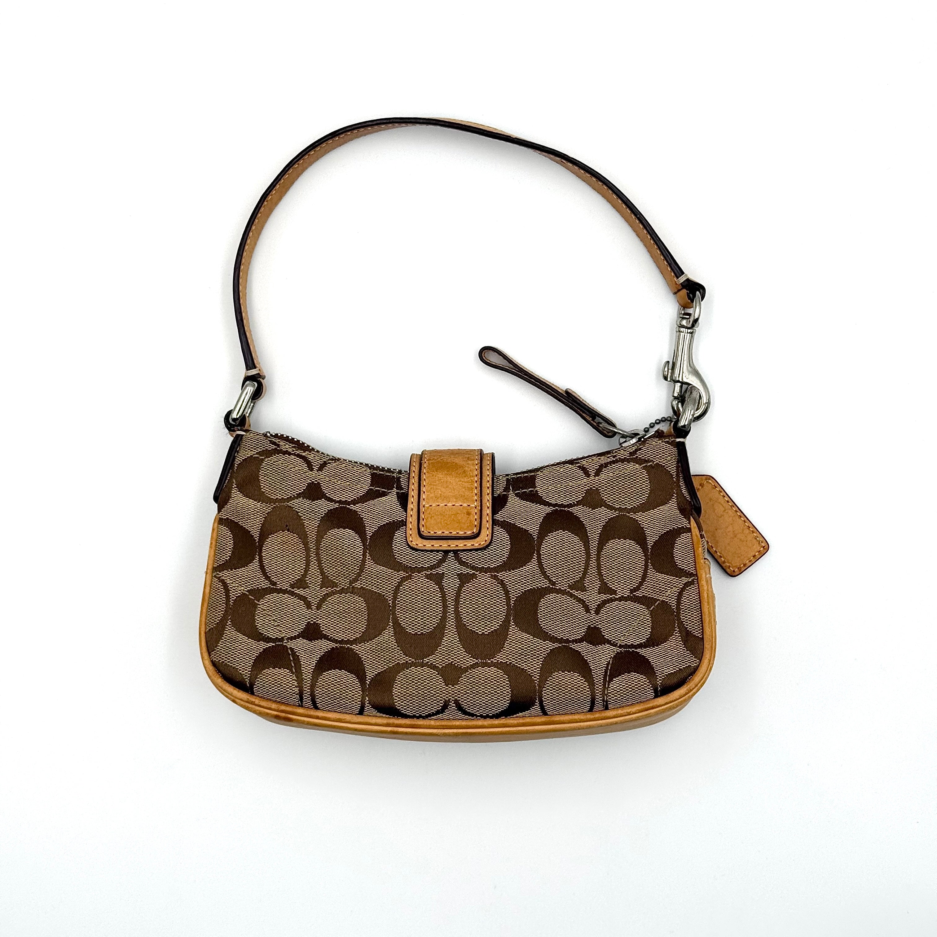 Coach Soho Demi shoulder bag in beige and tan monogram canvas with leather trim and buckle detail.