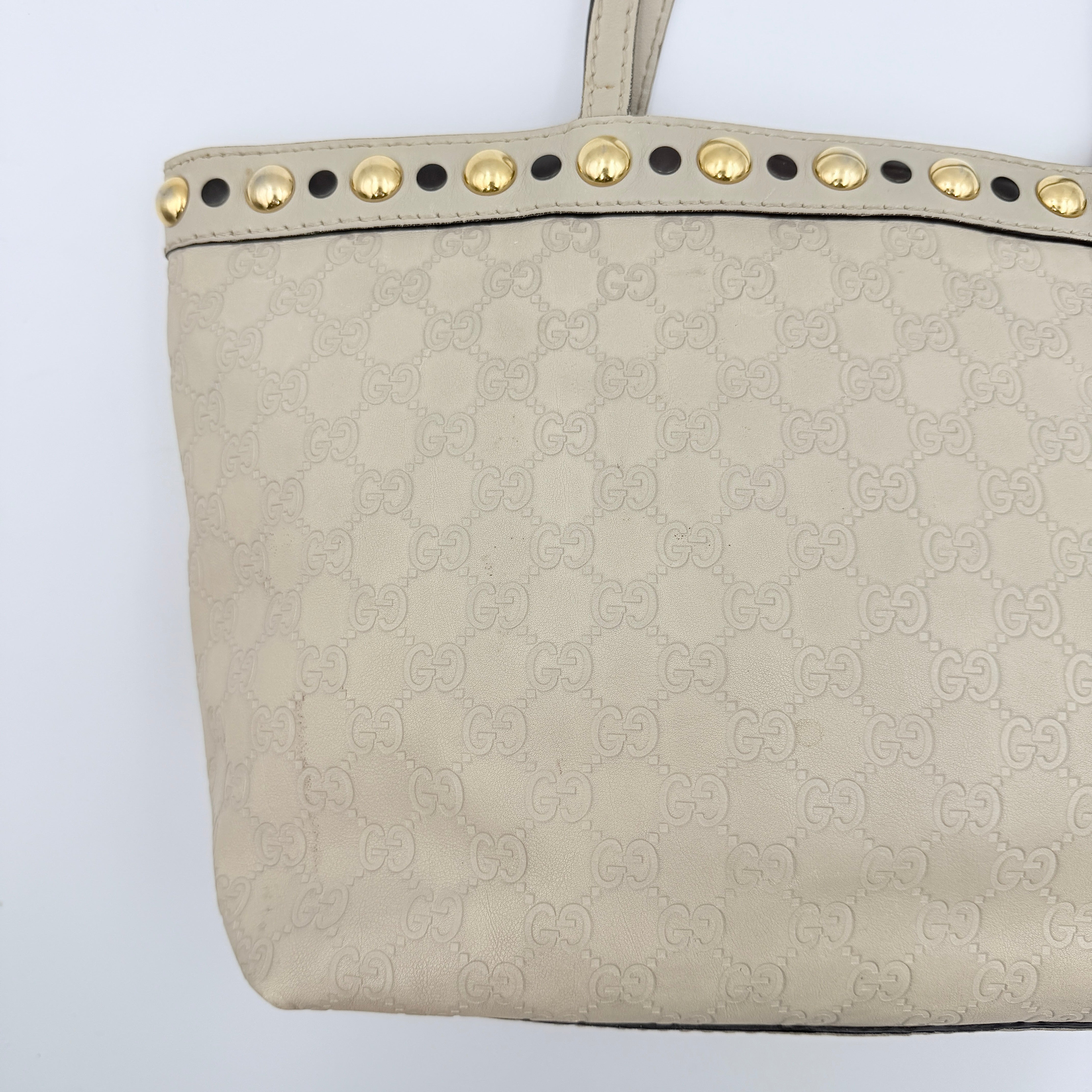 Gucci GG Monogram Babouska shoulder bag in cream canvas with gold-tone stud details and double top handles.