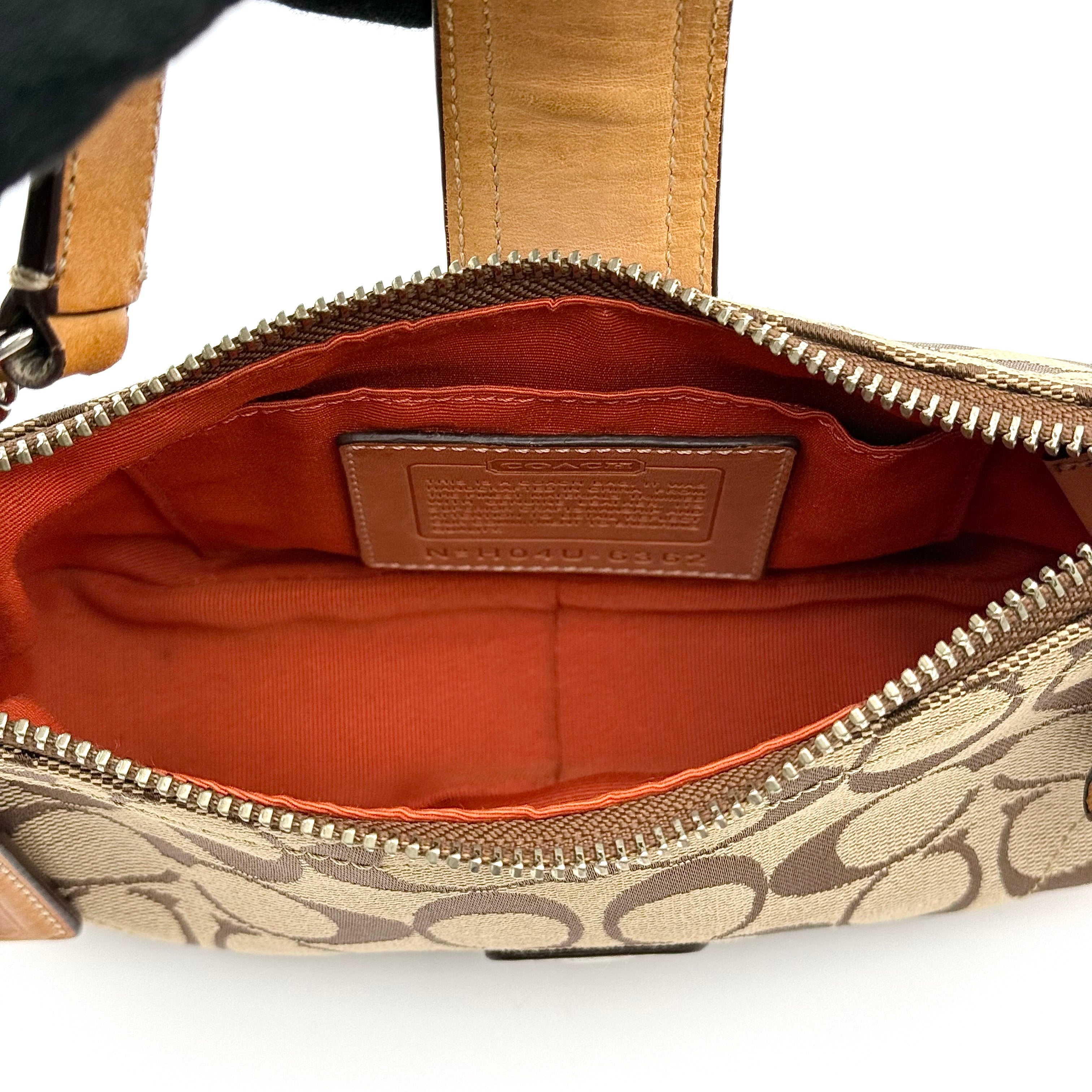 Coach Soho Demi shoulder bag in beige and tan monogram canvas with leather trim and buckle detail.