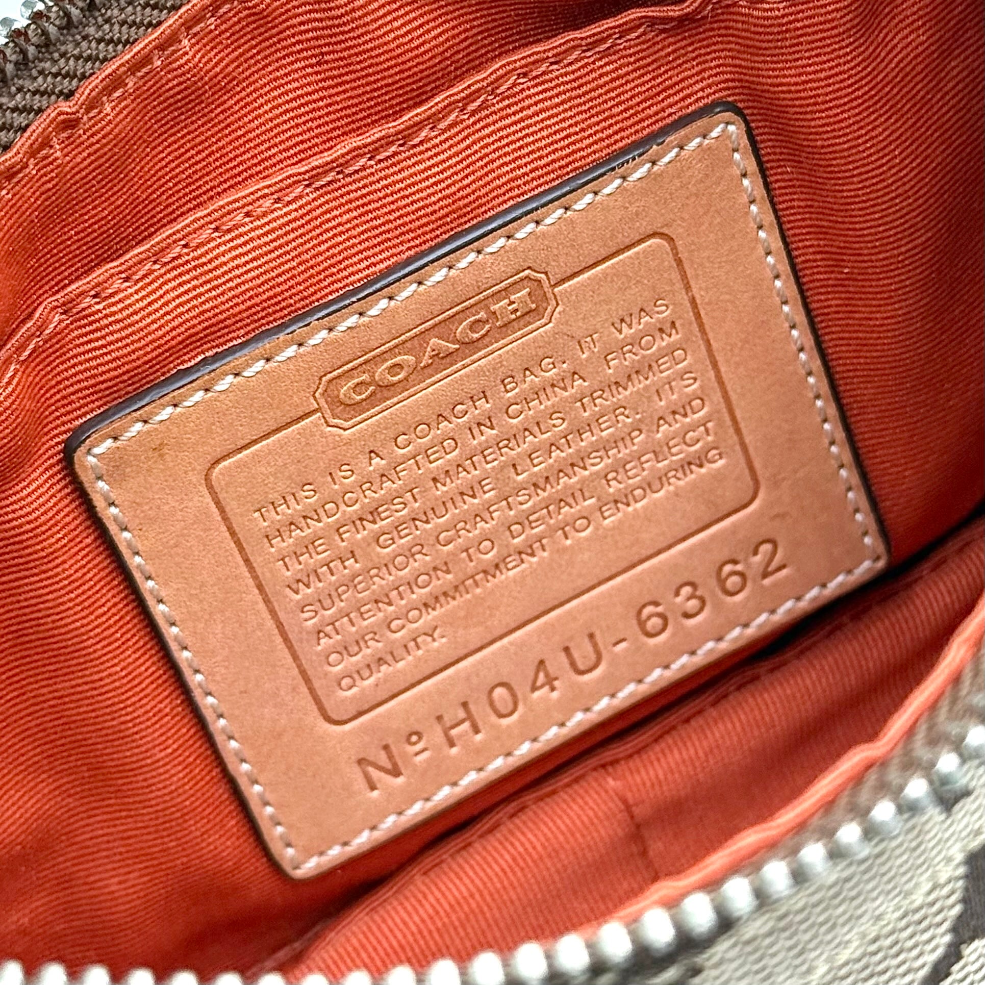 Coach Soho Demi shoulder bag in beige and tan monogram canvas with leather trim and buckle detail.
