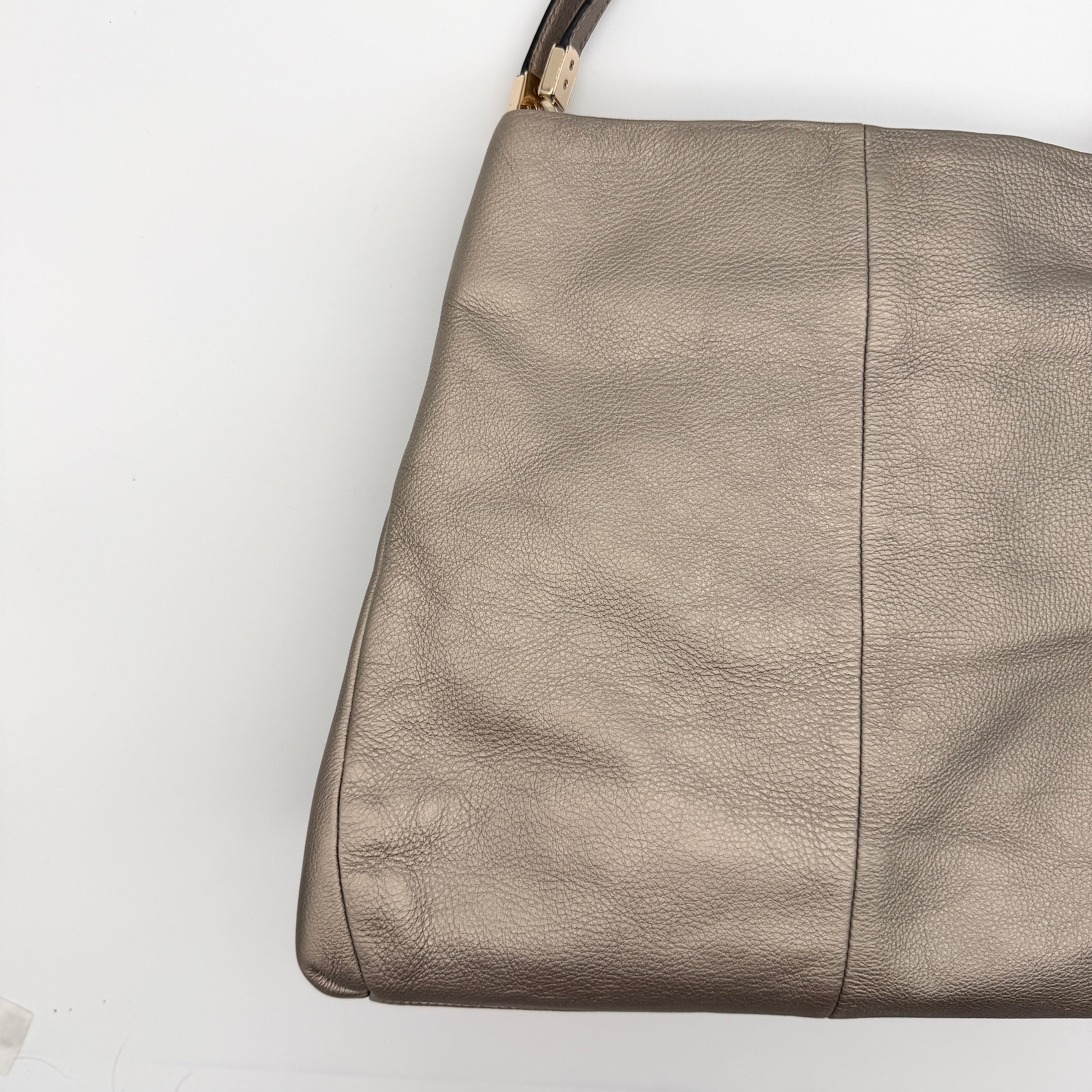 Coach Madison Phoebe shoulder bag in metallic taupe pebbled leather with dual straps and gold-tone hardware.
