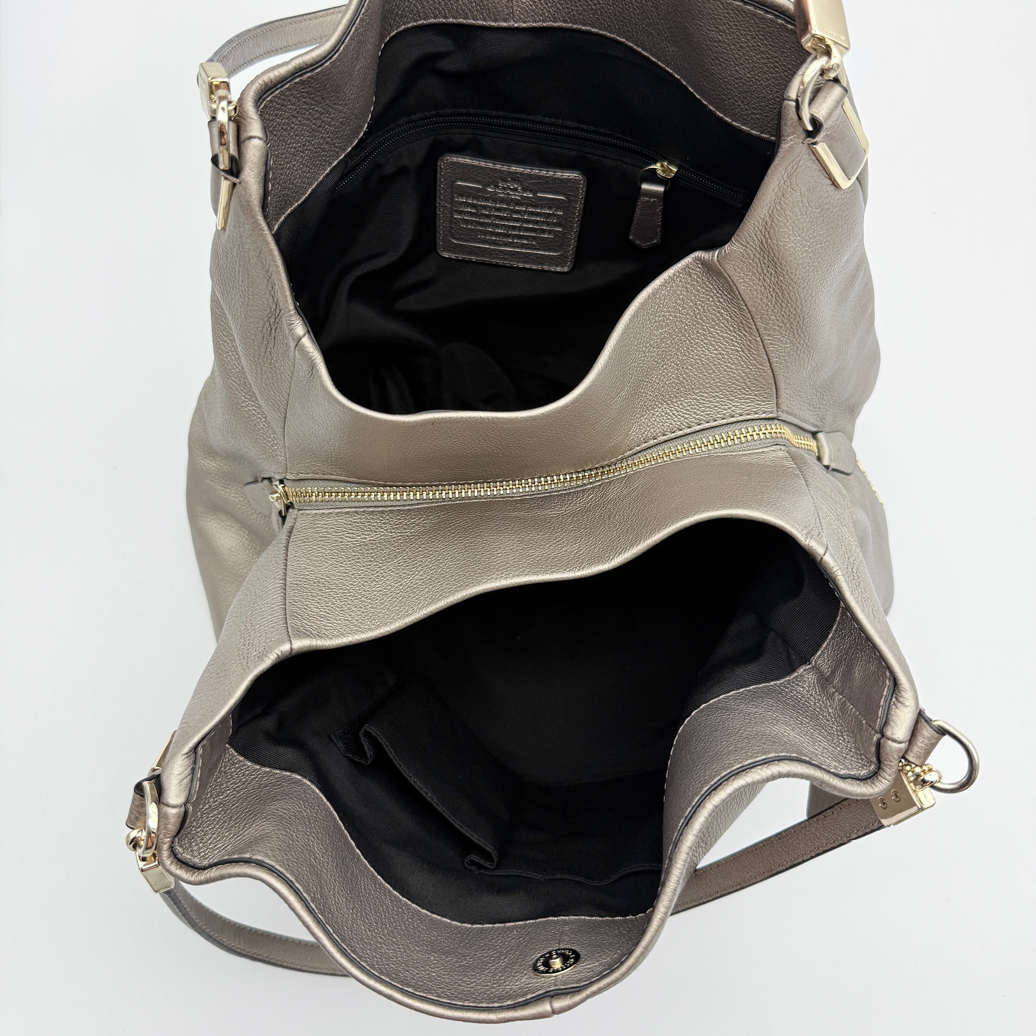 Coach Madison Phoebe shoulder bag in metallic taupe pebbled leather with dual straps and gold-tone hardware.