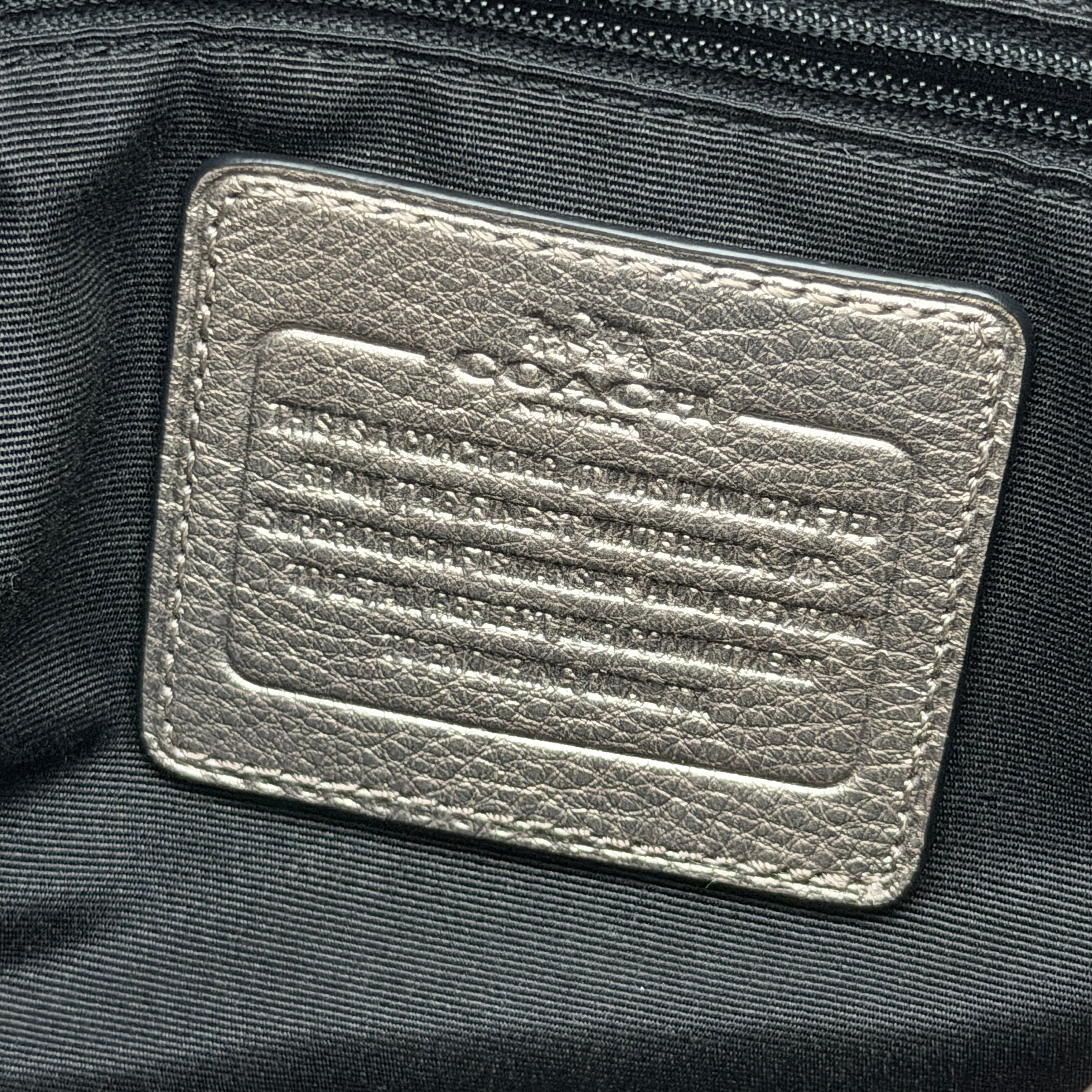 Coach Madison Phoebe shoulder bag in metallic taupe pebbled leather with dual straps and gold-tone hardware.